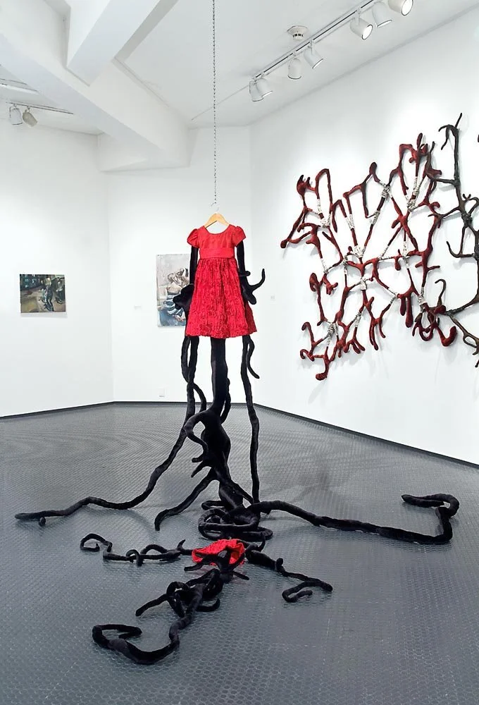 Replicant Hybrid. Black velvet, matching children and doll red dress, batting and sewing. Approximately 7x 5x6ft