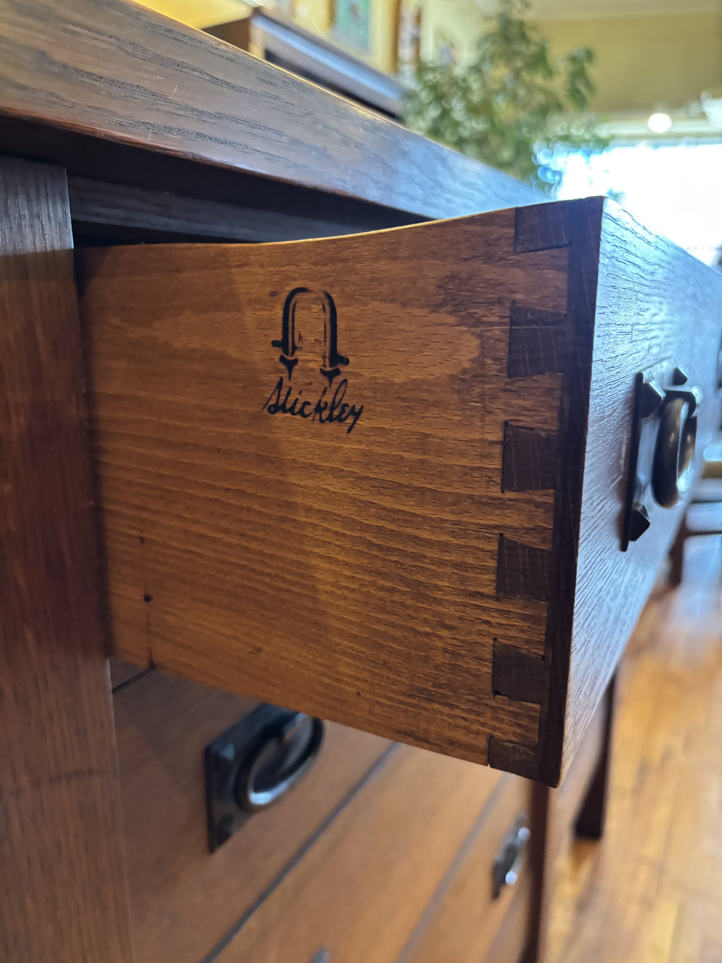 Close up of burn mark signature on Gustav Stickley sideboard