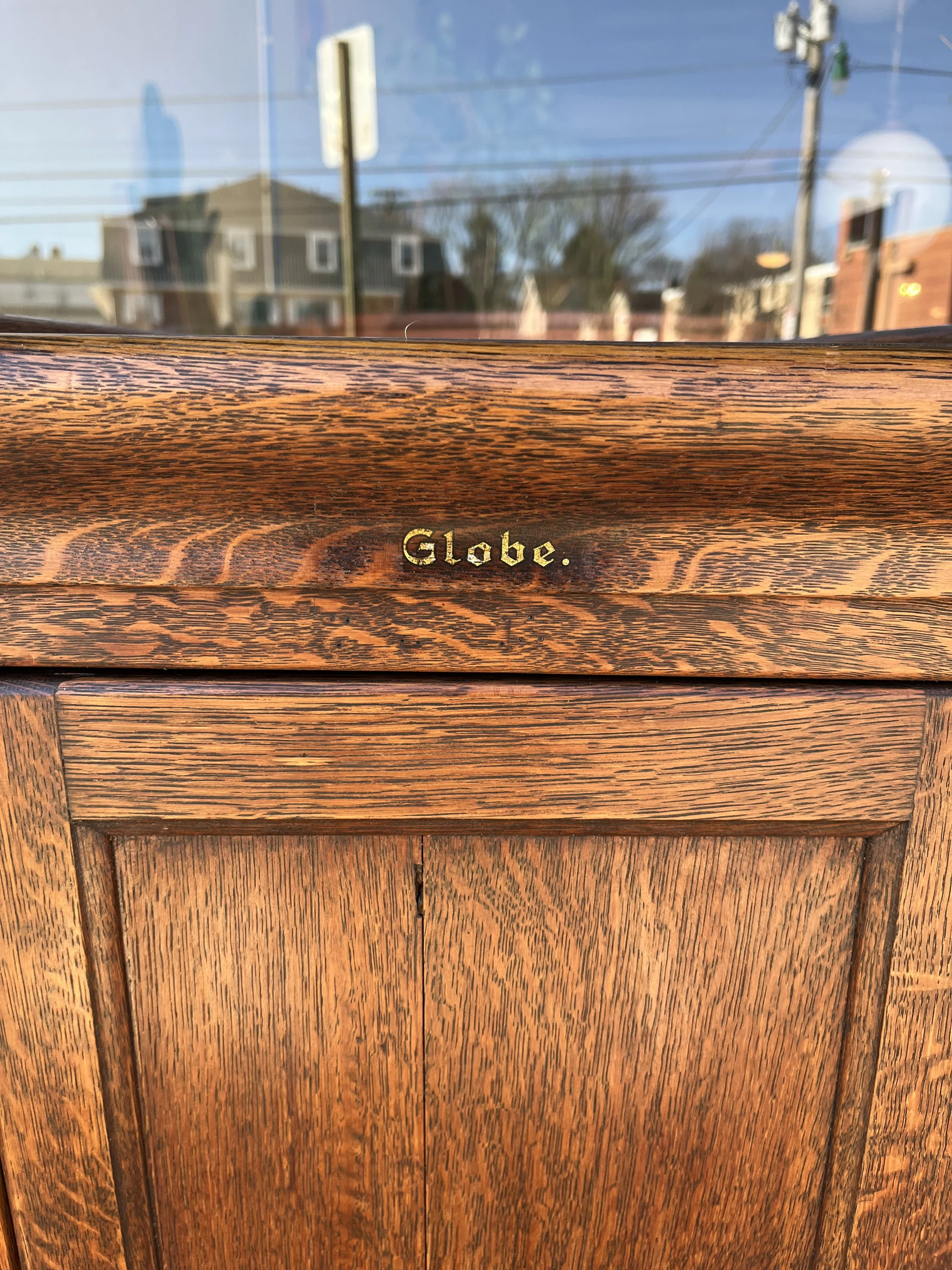 Globe makers make with gold lettering