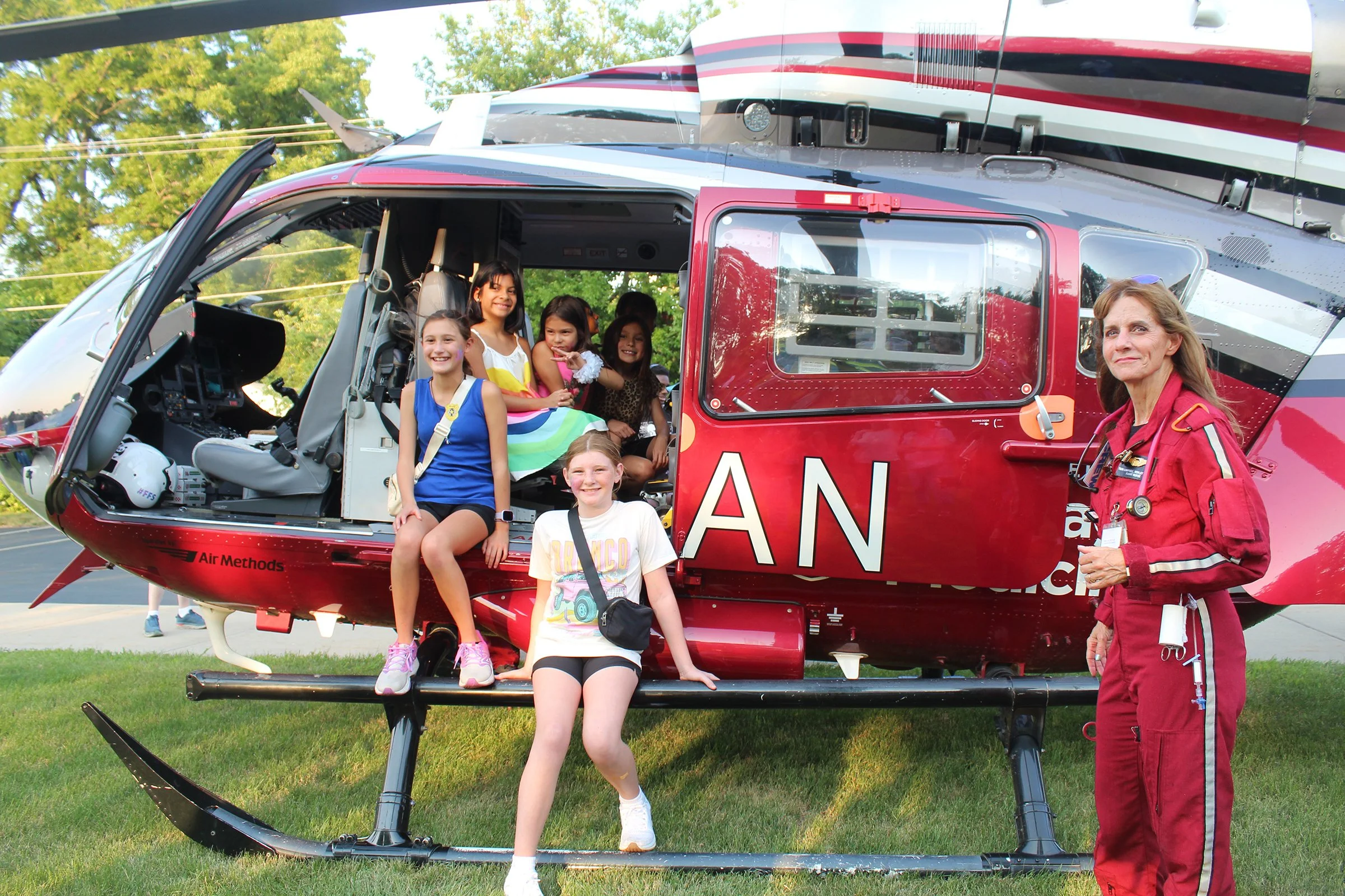 Young kids sit inside a helicopter