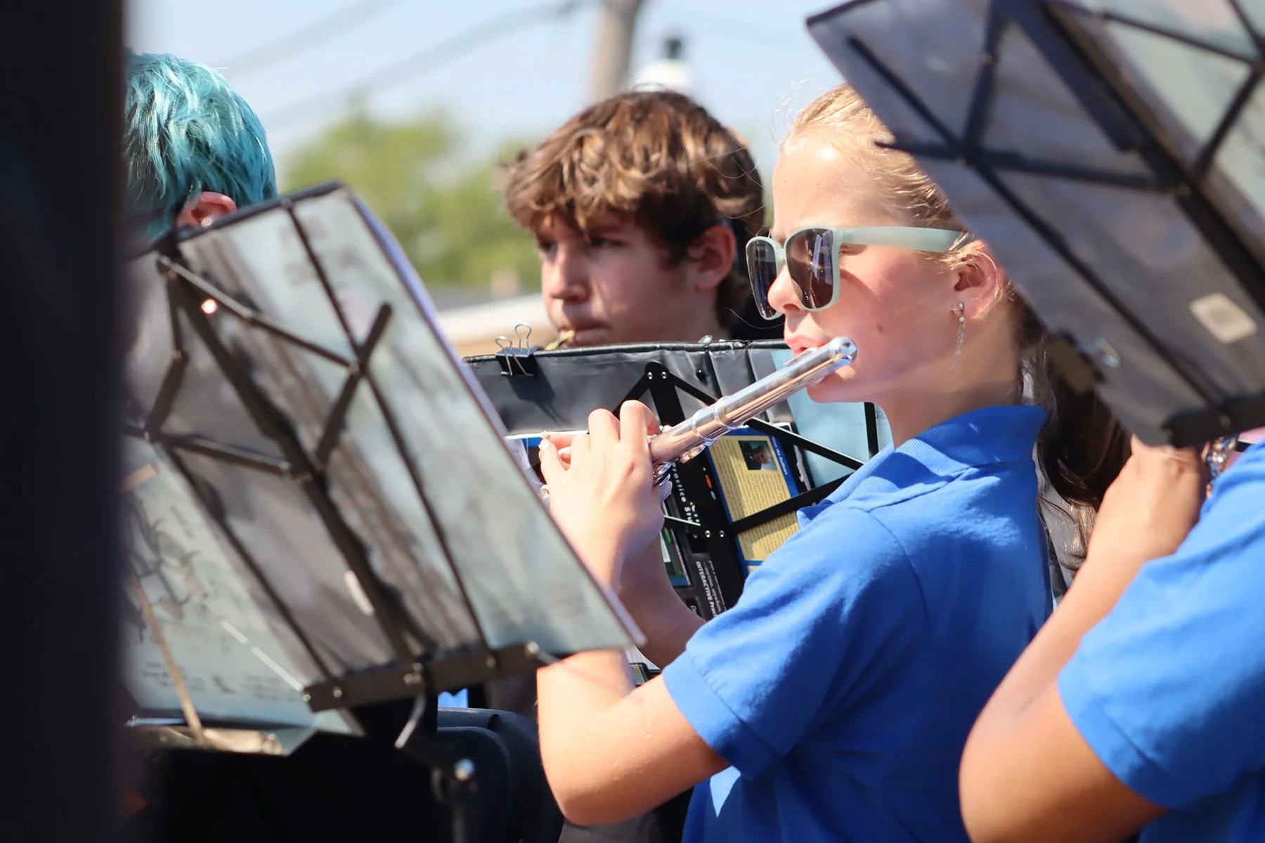 Young students play instruments outdoors