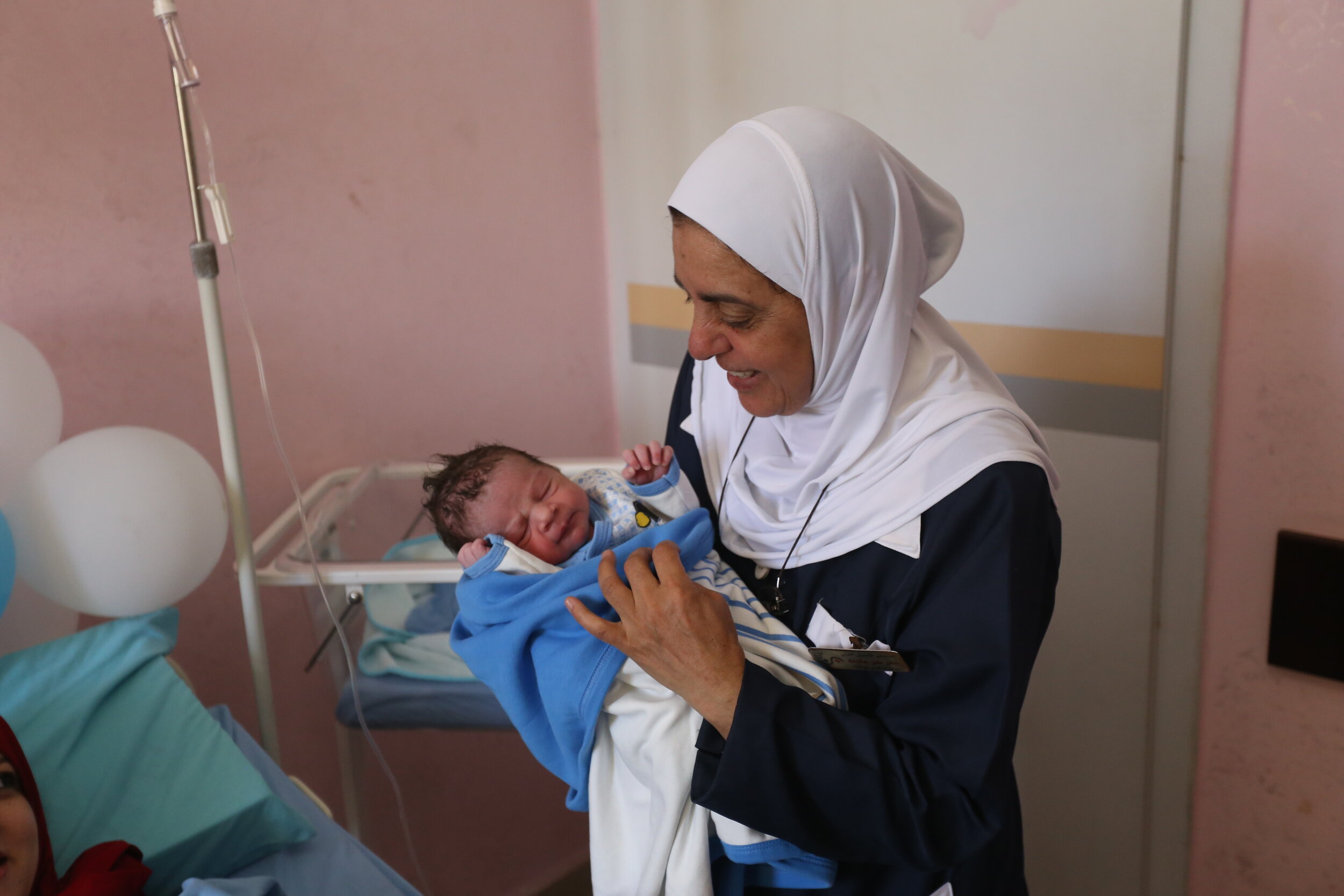 Doctor with new baby, St Luke's, Nablus.JPG
