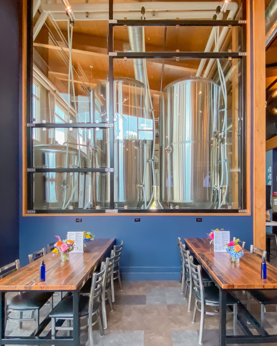 Private brewery event space with long banquet tables inside Royal Bliss Brewing in Denver, NC.