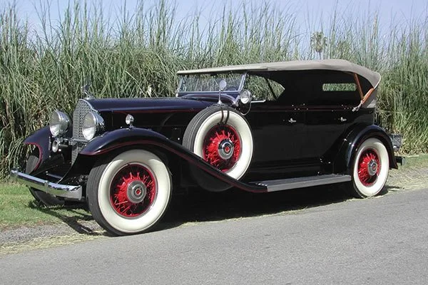 Black 1930s phaeton with red wheels