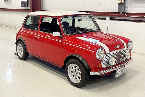 Red classic Mini with a white roof
