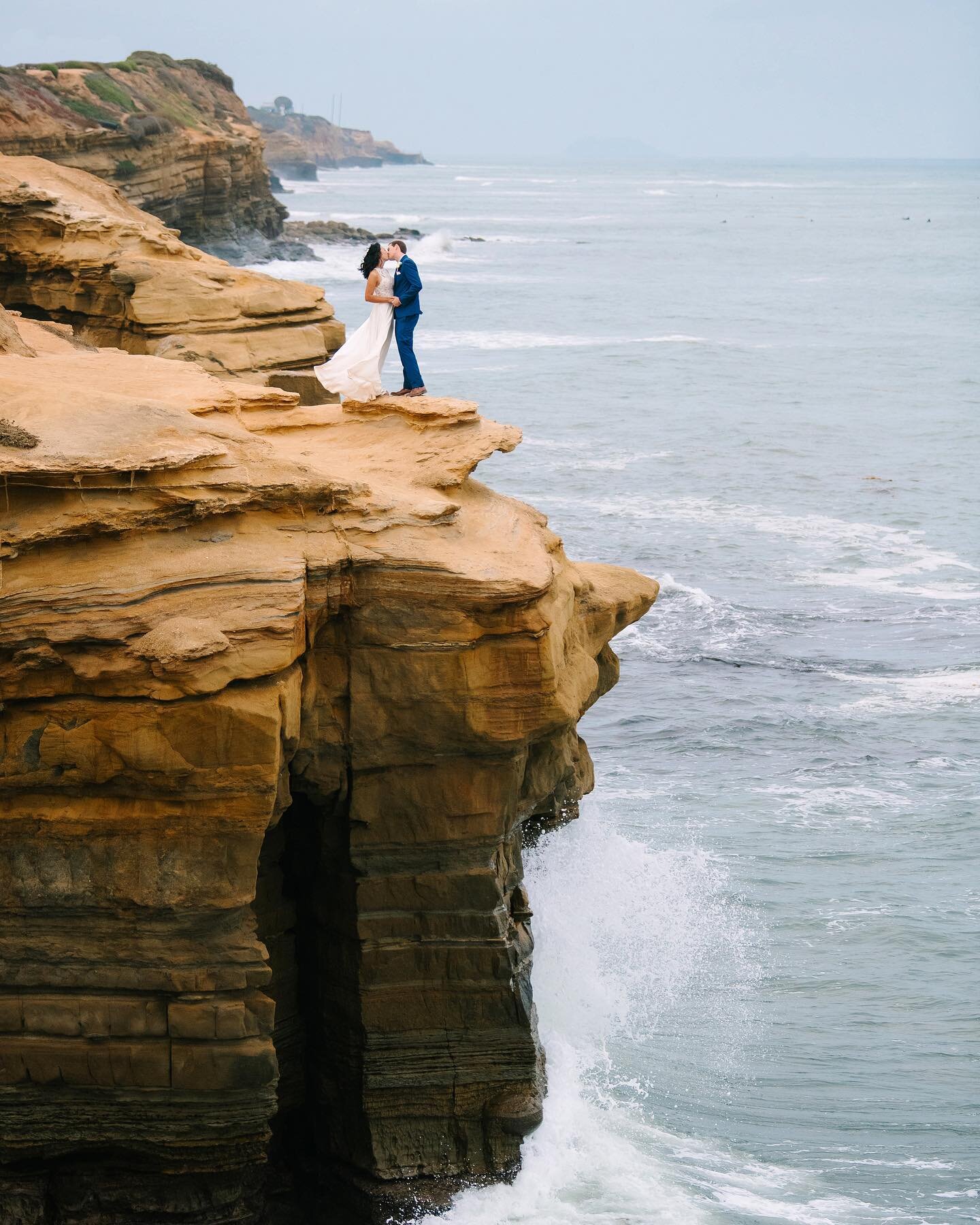 Even on the gloomiest of weather days, something beautiful and magical can still happen. ✨ Congratulations Cheryl + Foster!

Planner: @ahundredheartssd 
Ceremony: Sunset Cliffs
Flowers: @flowers_of_pl 
Cake: @europeancakegallery 
Catering: @bekkersca