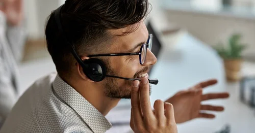 IT help desk technician assisting a user over the phone