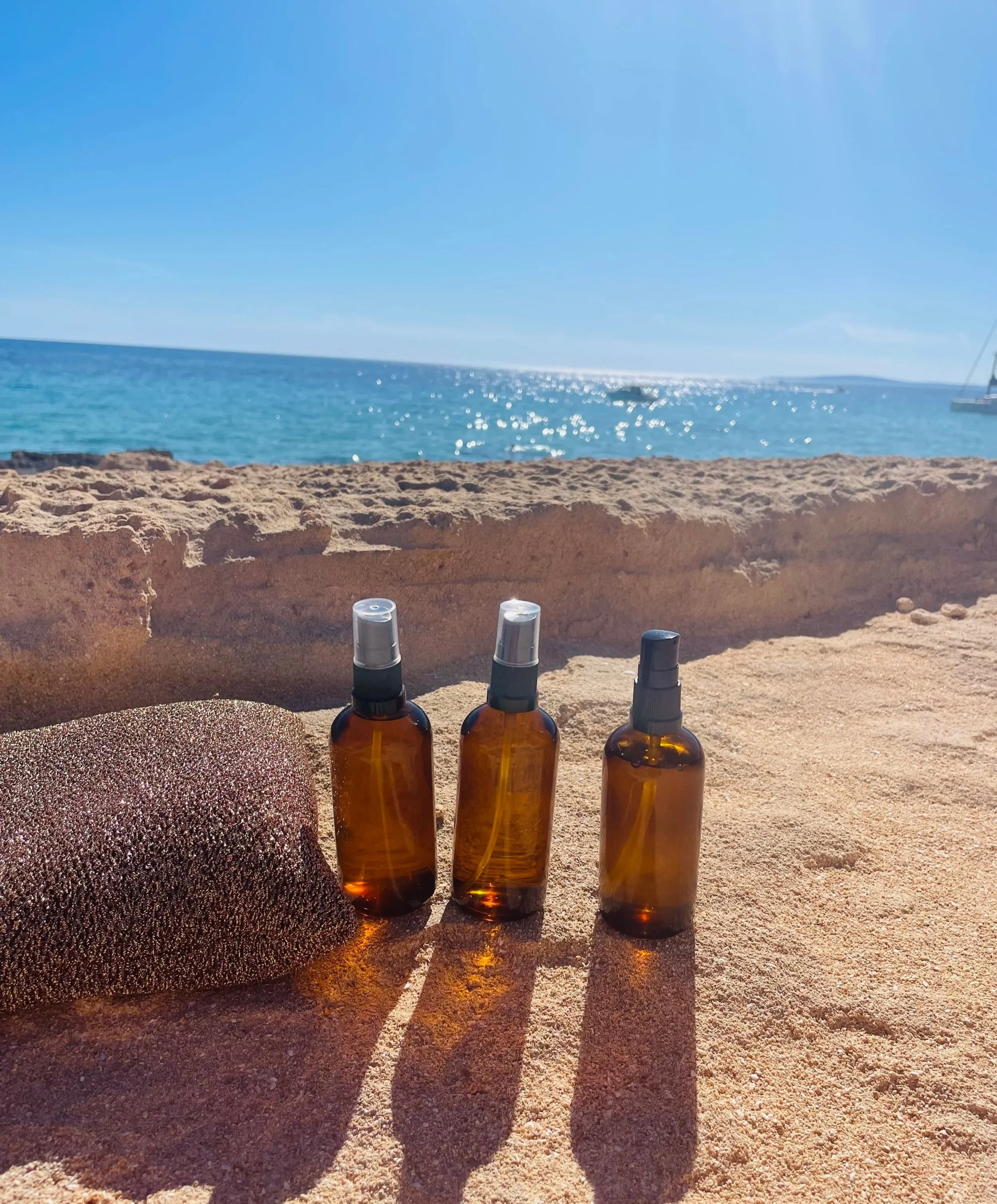 Summer nail care essentials including cuticle oil and sunscreen for healthy gel nails.