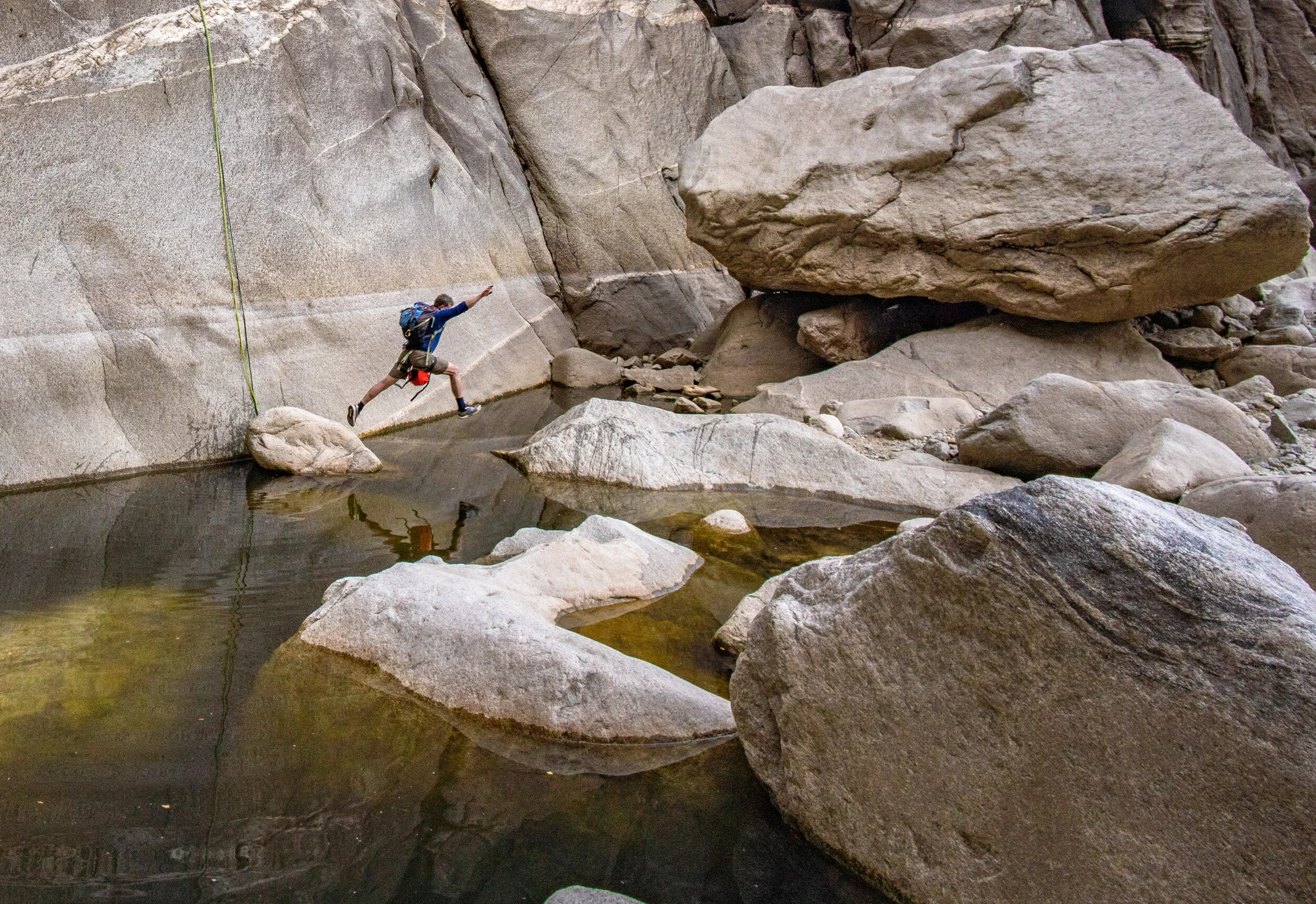 Staying dry at the base of the final rappel. 