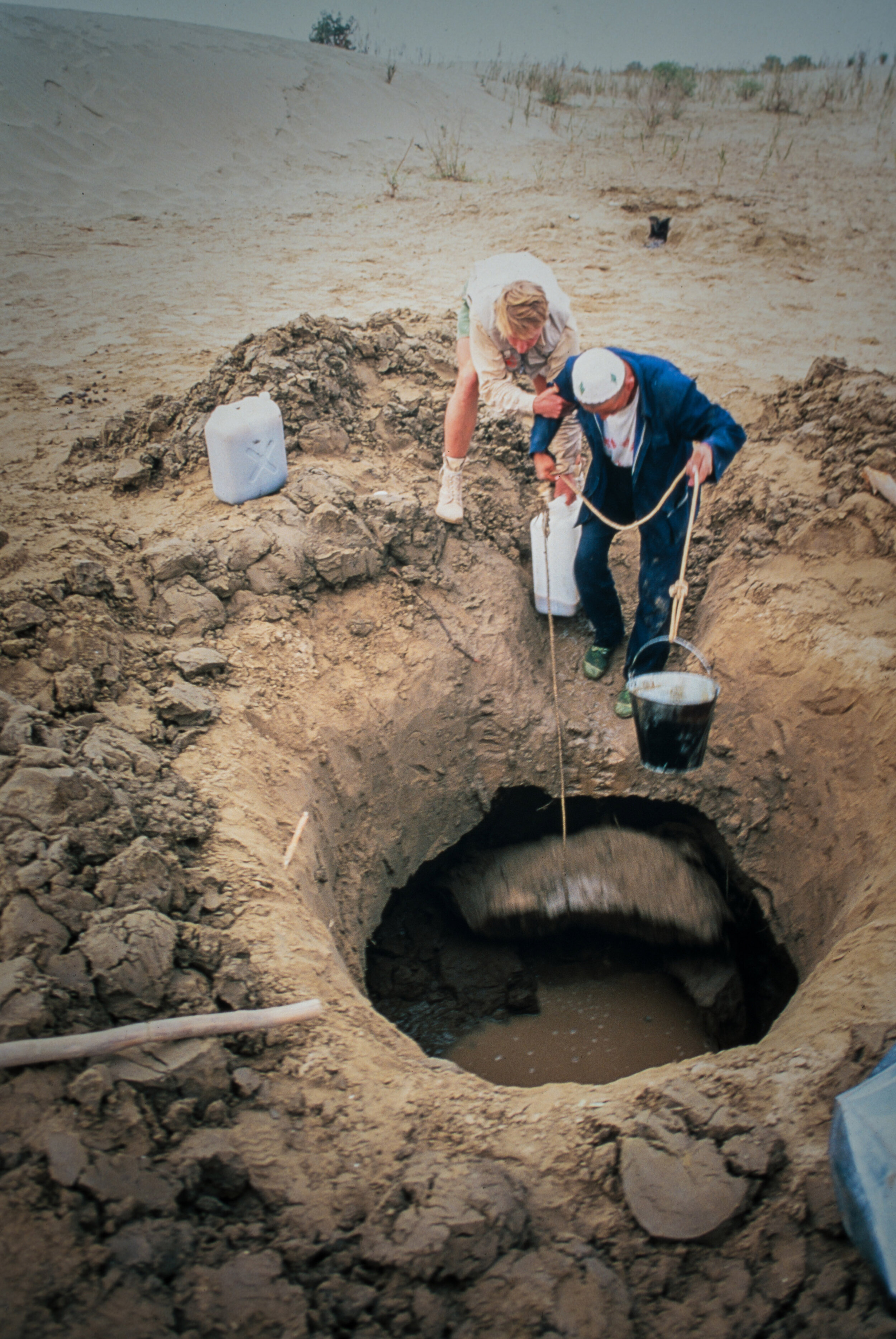  Most evenings the crossing team had to dig an enormous pit to find water for the camels to drink. Sometimes retrieving water from it could be dangerous.  