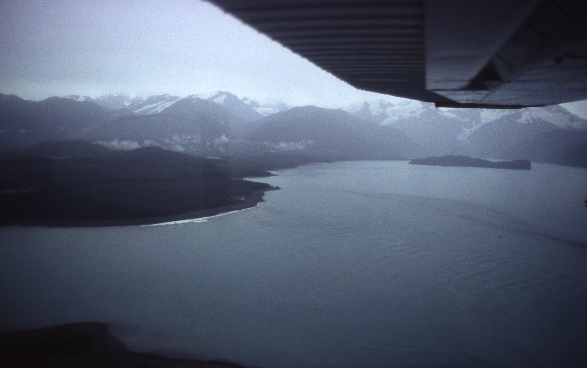 Looking for a place to land after a one hour flight from Yakutat Alaska, our bush pilot scans the beaches of Lituya Bay.  