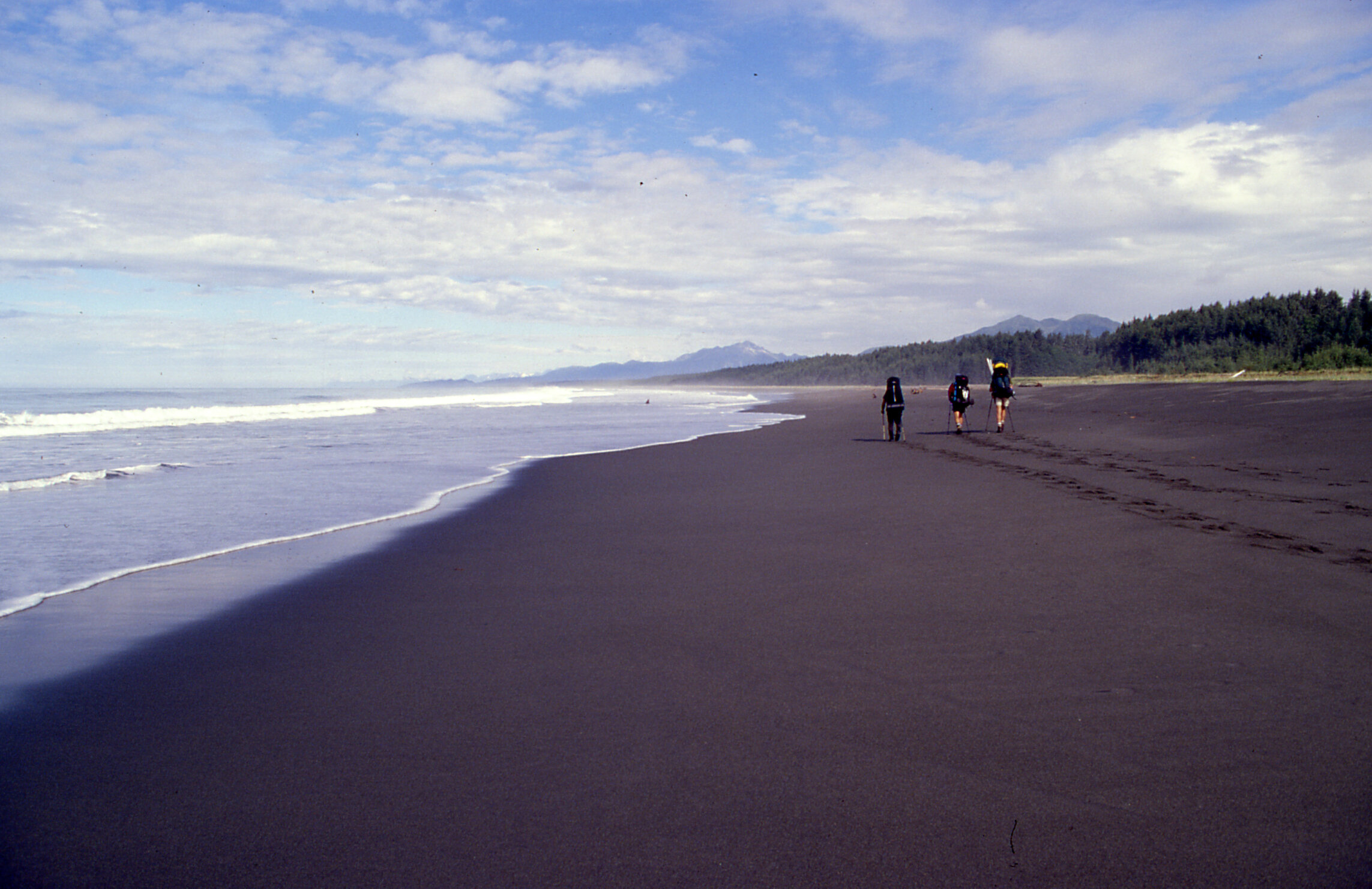  Frequently while walking along the beach like this we could tell when our next major river crossing would be not by seeing the river itself up ahead, but by seeing the massive muddy breakers off-shore created by the outflow of water into the surf.  
