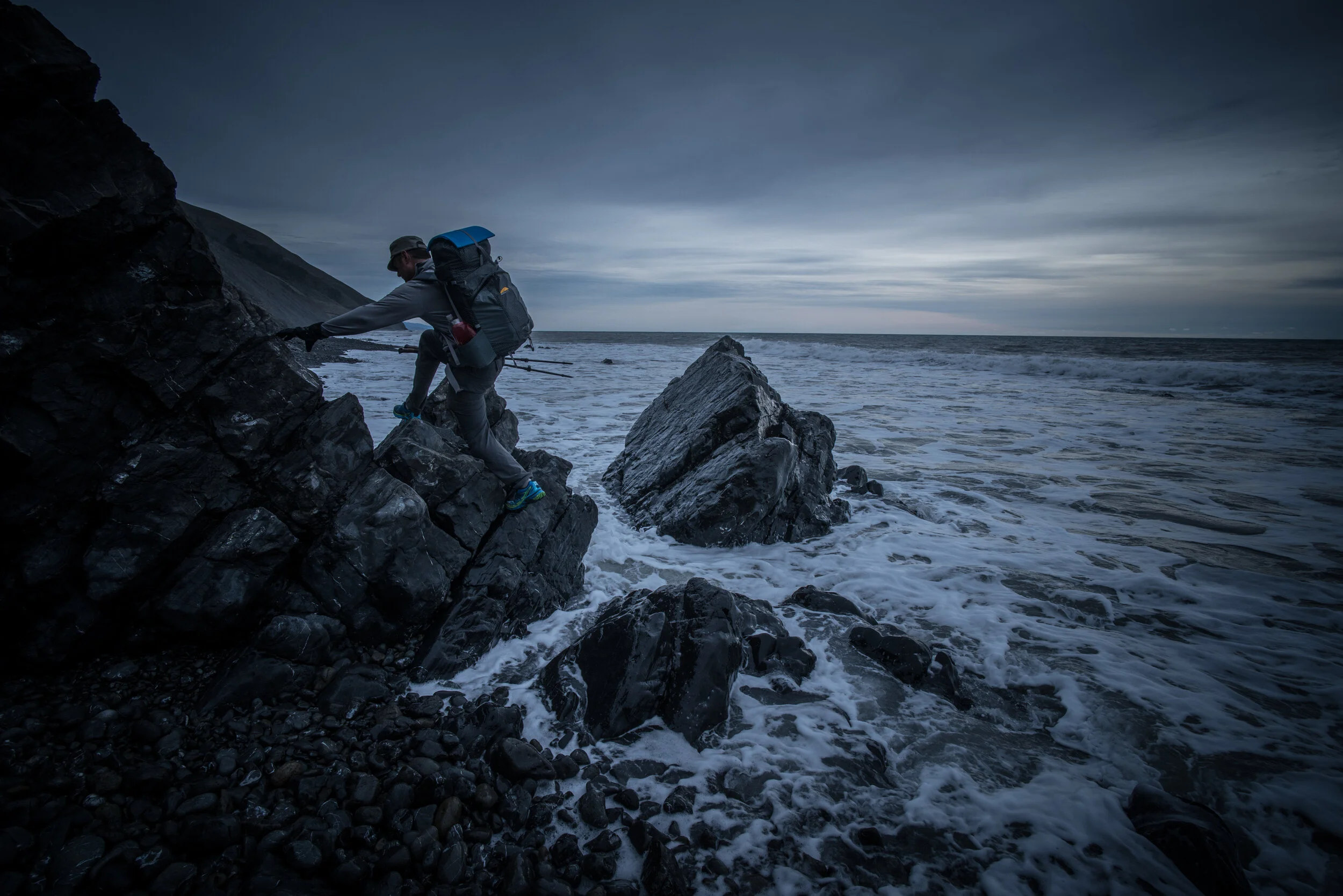  Scott negotiates the fine line between cliff and surf along the Northern section of low tide hiking only zone. 