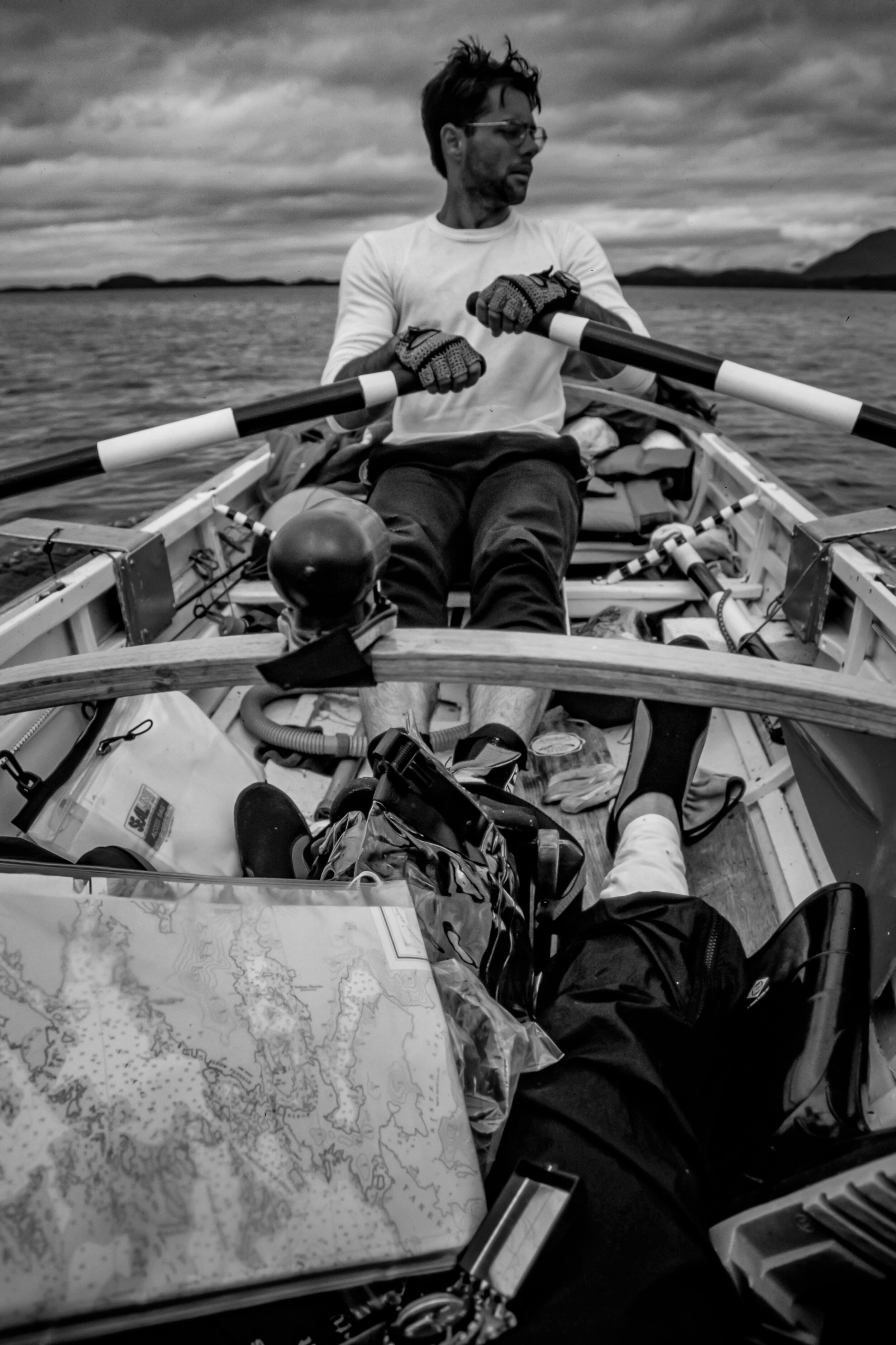  He is the viewpoint of the navigator seated atop gear in the stern of the boat. There is in no seat for anyone besides the rower.  