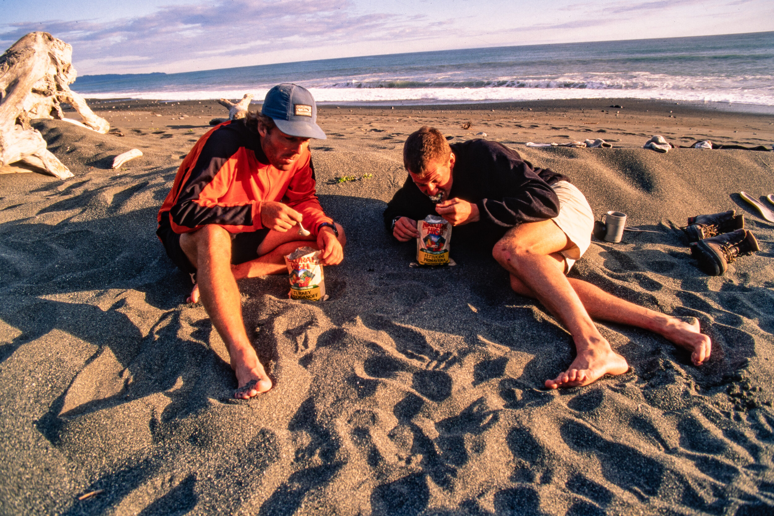  Tom and Rupert fueling up and airing their feet out. Evenings on the beach were magical if the sun was out. Look closely and you will see a little stream in the back left corner of this photo. As waves came up the beach salmon would make a break for