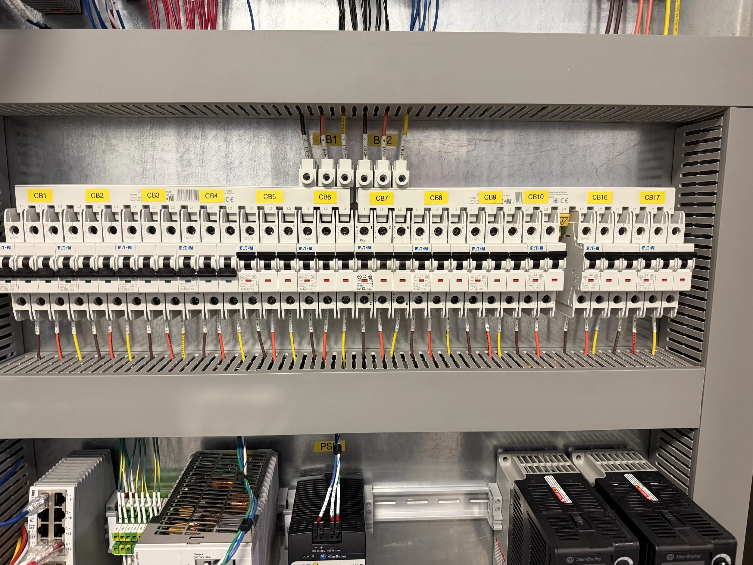 Electrical control panel with circuit breakers and wiring.
