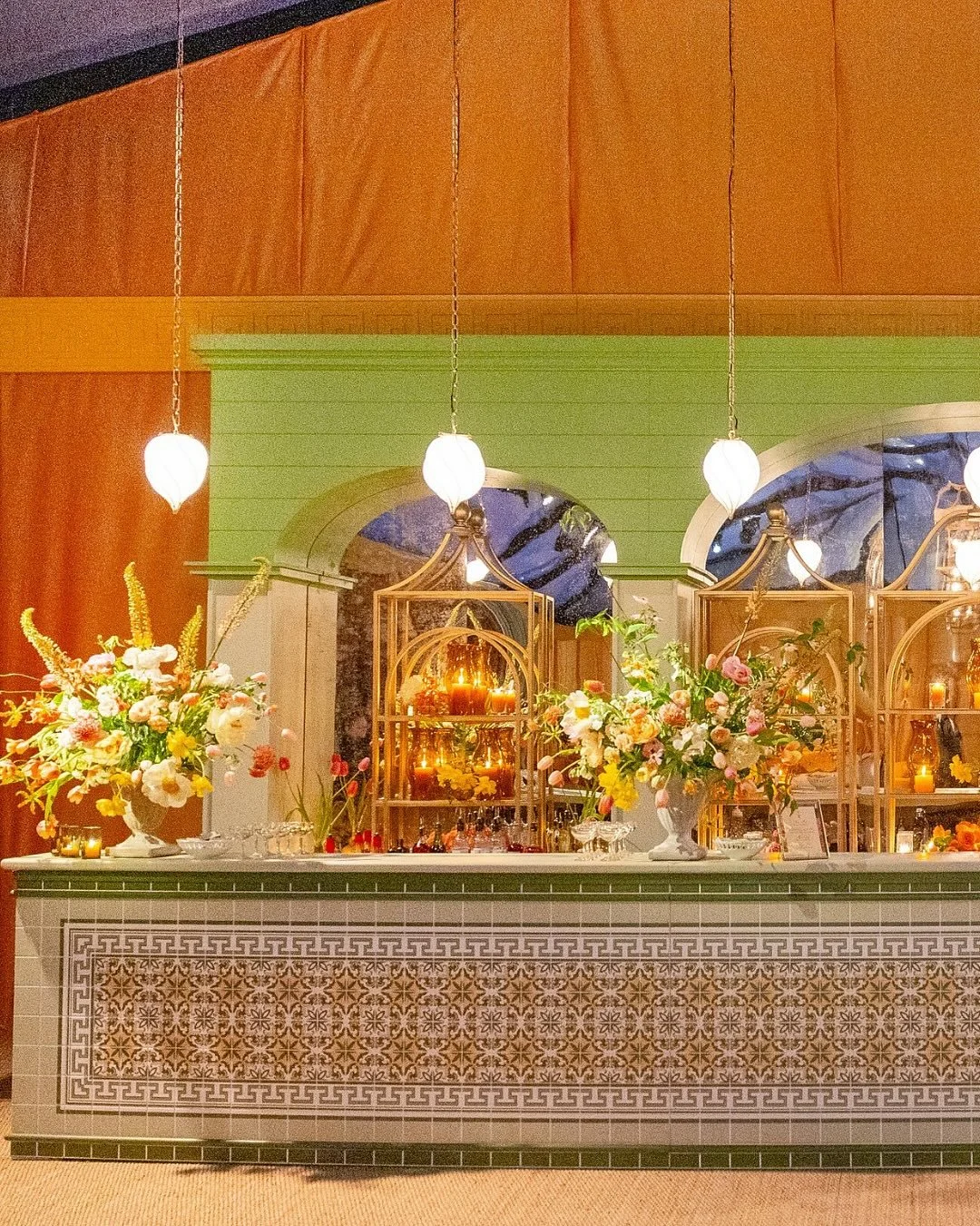 There are so many elements of Coley and Will&rsquo;s dancing tent that we love.

Tonal saffron banquettes and caf&eacute; tables lined one side, while our tiled bar anchored the other. Overhead, custom @eandsimports iron fixtures for @technicalevents