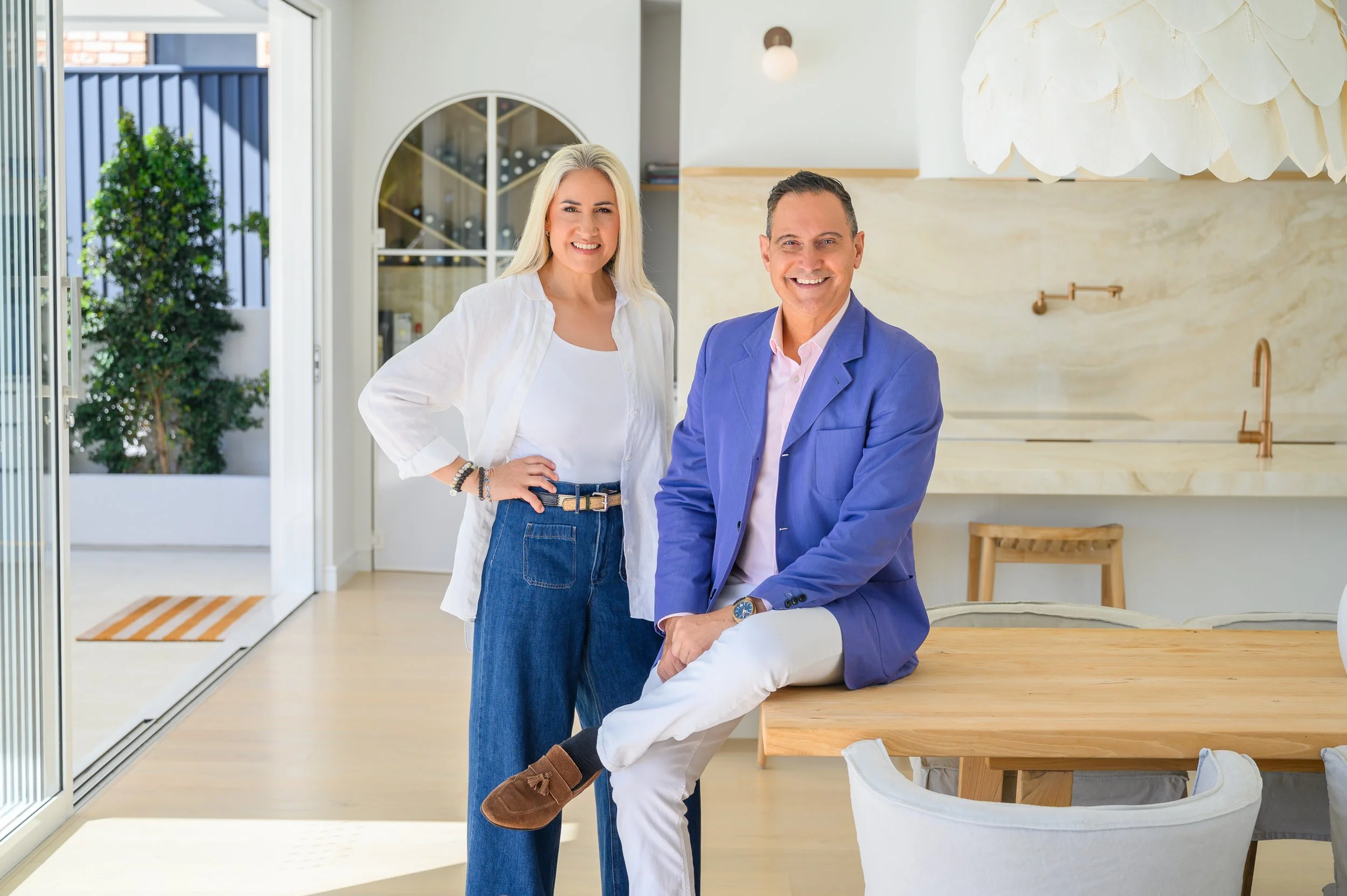 Roberto and Lisa inside a contemporary Gold Coast home with a wine cellar.