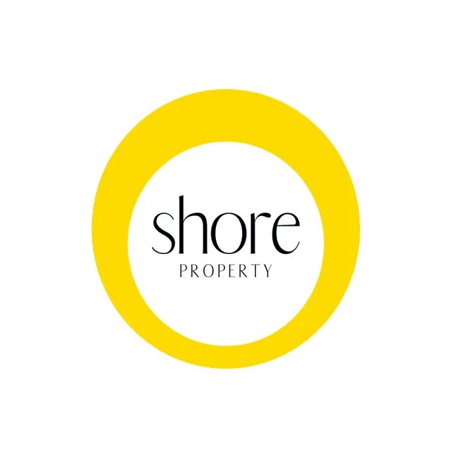 Logo for Shore Property featuring a yellow circle and the words 'shore PROPERTY' inside in black text.