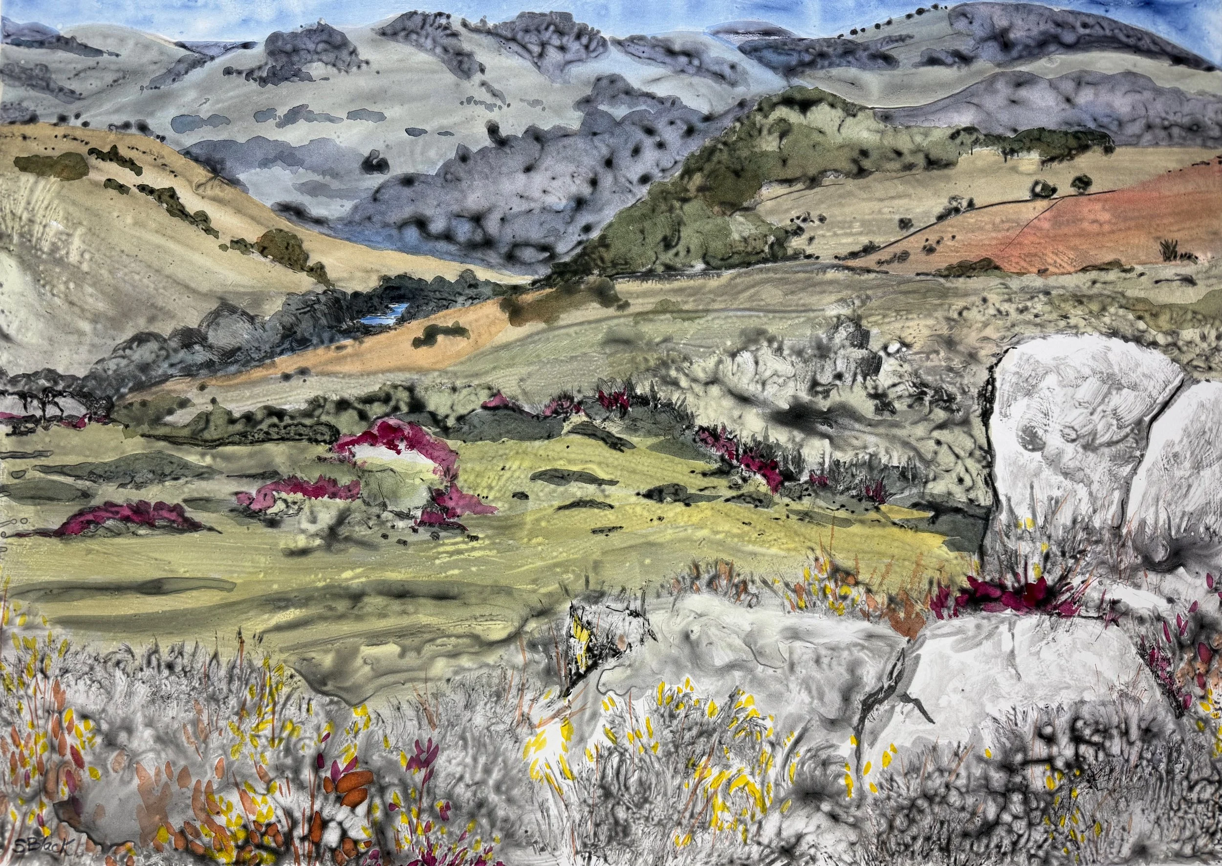 Landscape monoprint with mountains, boulders and a blue sky