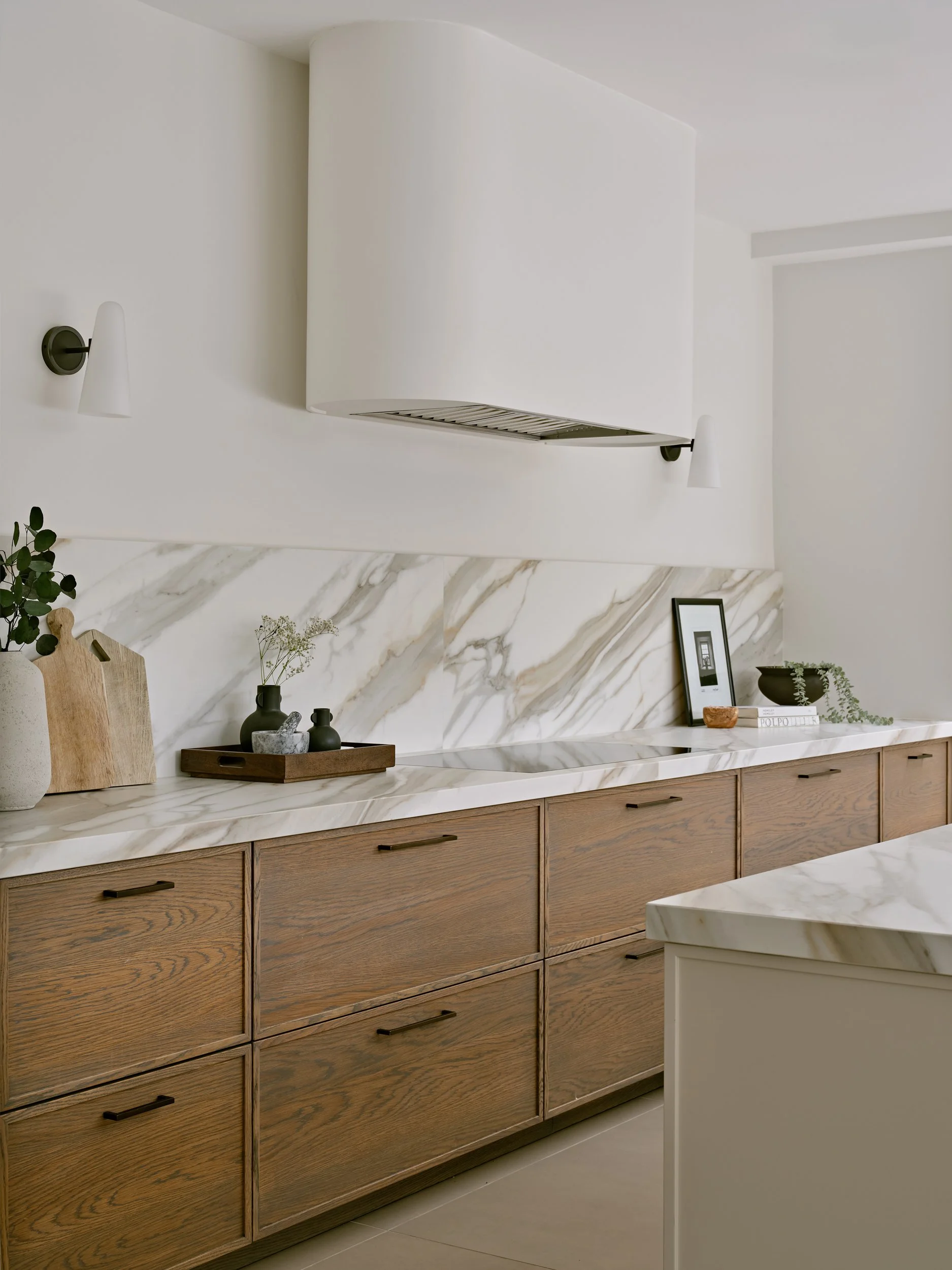 Micro shaker Kitchen, oak veneered, with Sapienstone worksurface and bespoke curved extractor chimney