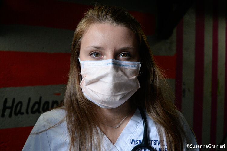 Ashley Valentino wears her surgical mask along with her Western Connecticut State University scrubs, which she would be wearing for her hospital rotations prior to COVID-19.