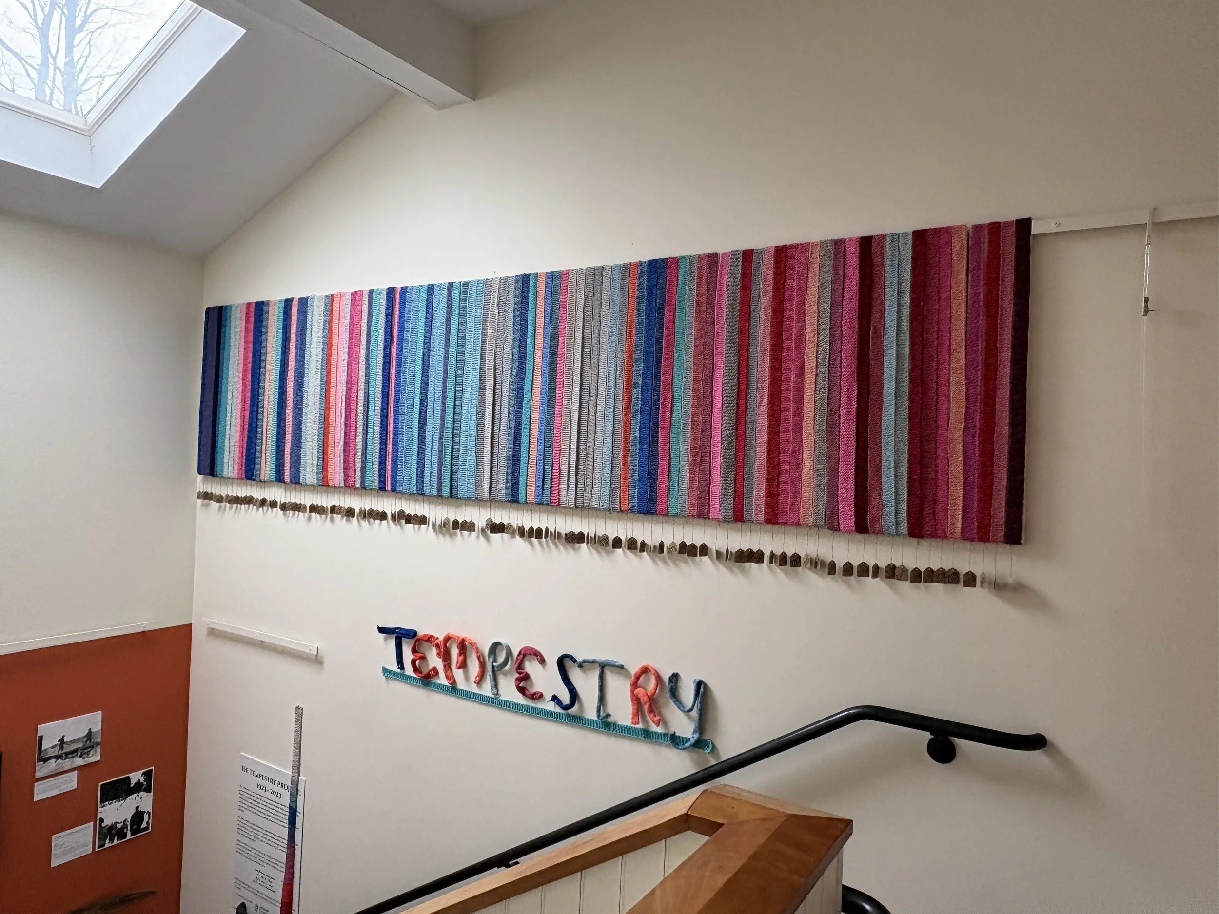knitted strips of Addison County data displayed on the wall of the Sheldon Museum