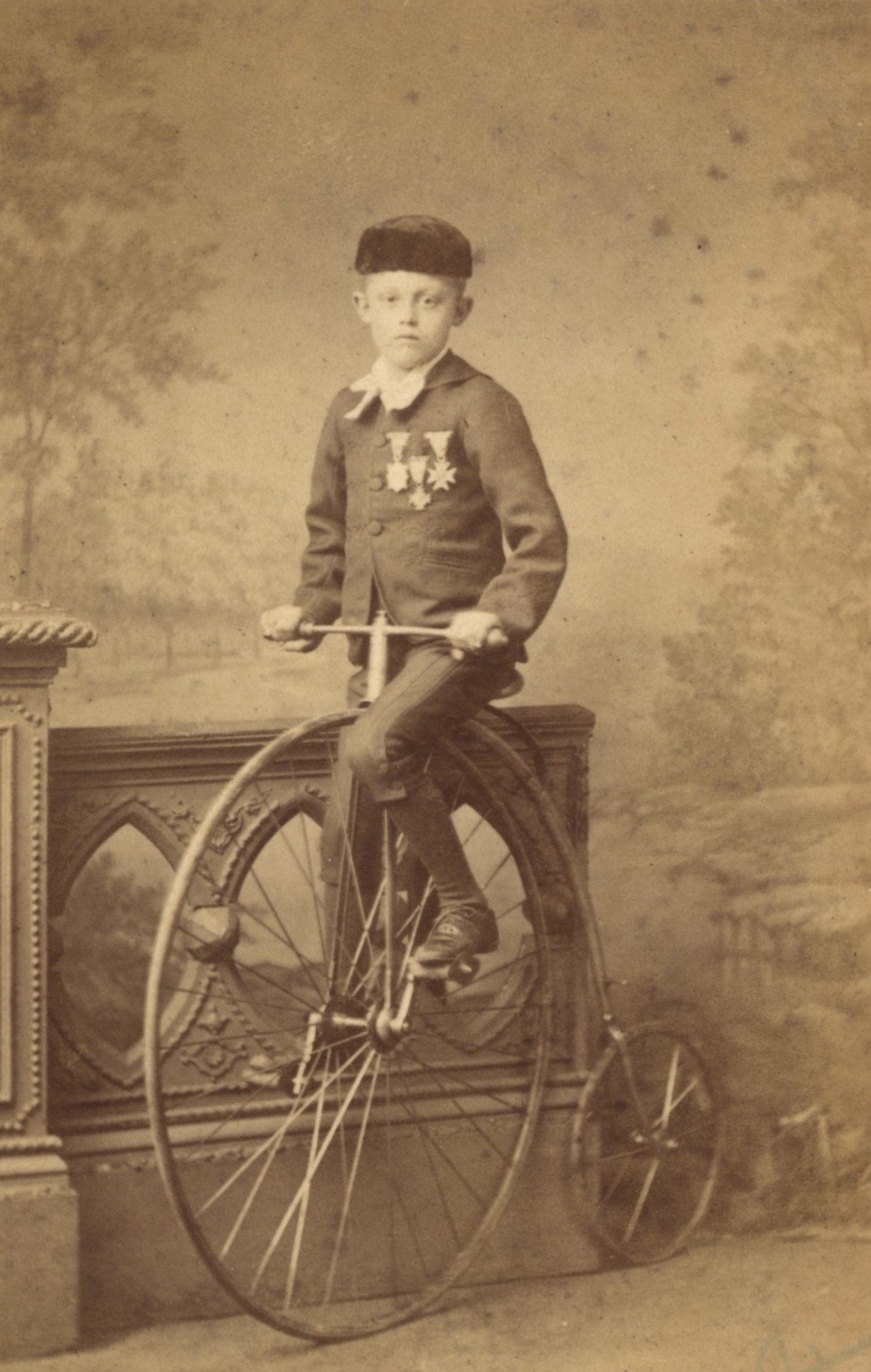 Child with ordinary bicycle and medals