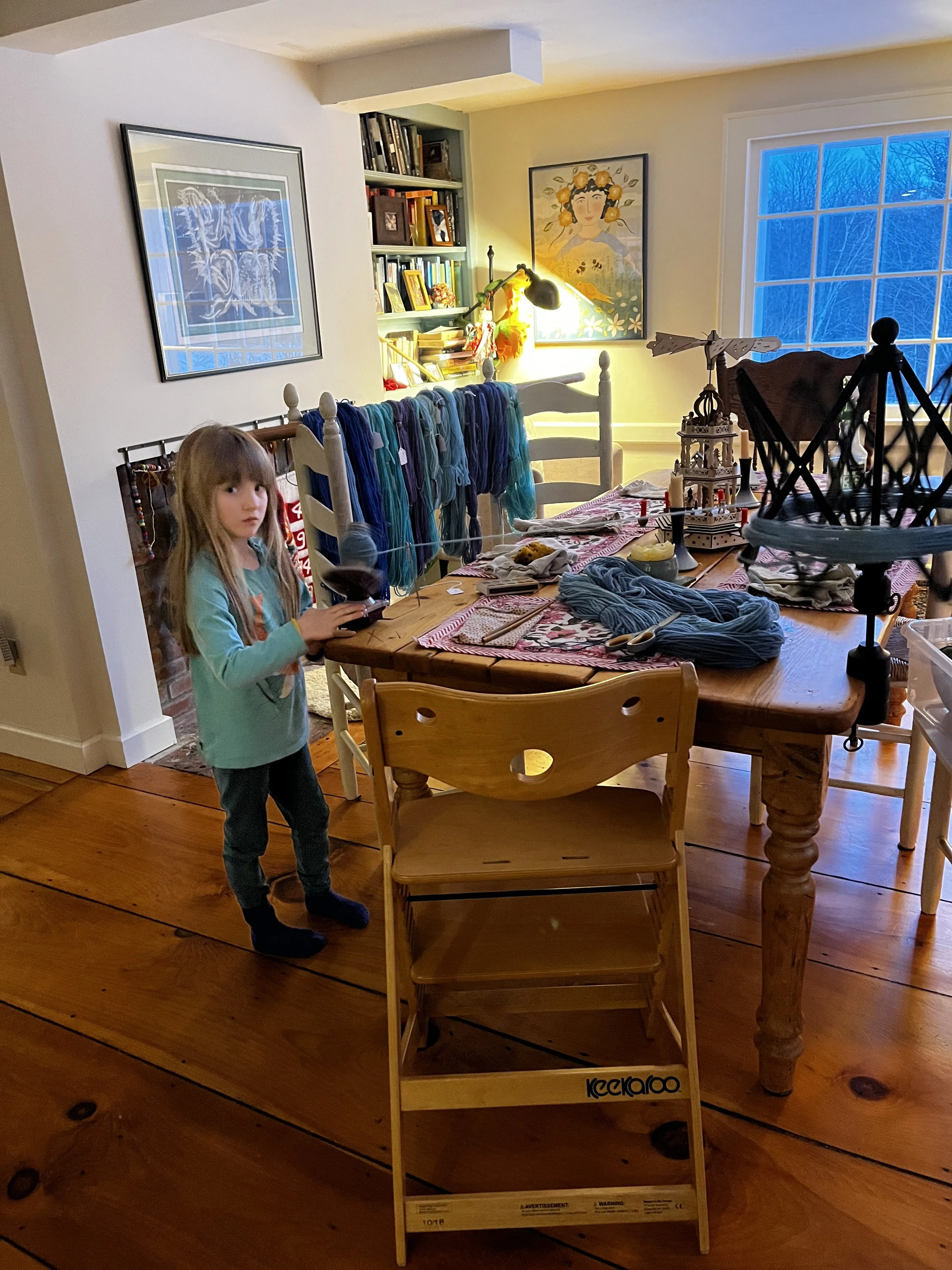 Louisa Moseley helps wind balls of yarn for community knitters!
