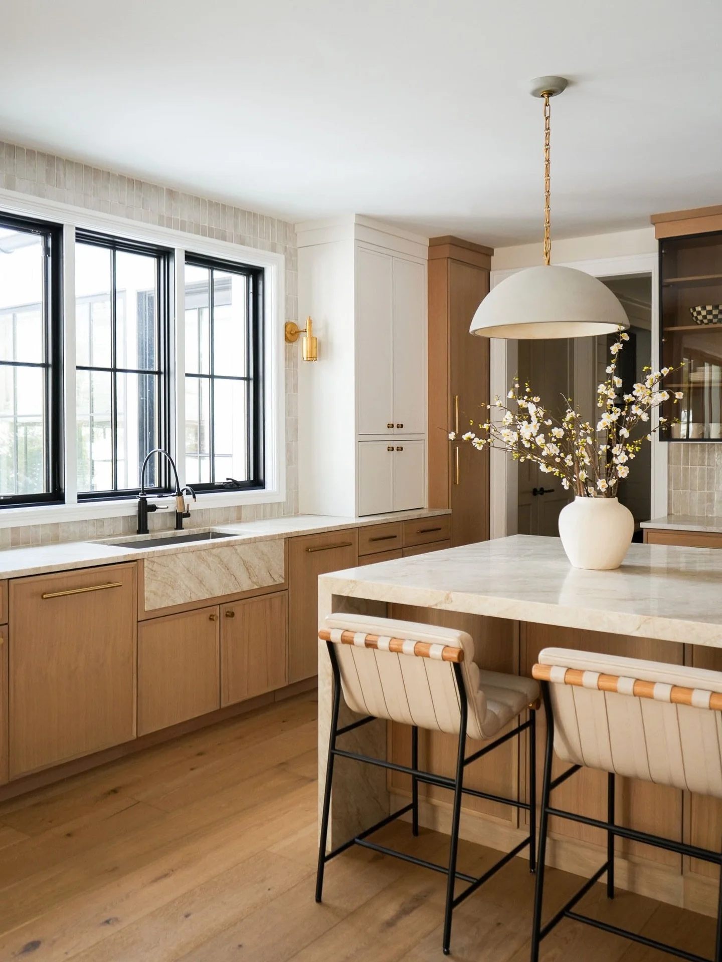 Flat panels, warm wood, and smoked glass cabinets. A little sneak peek of a kitchen designed to feel as good as it looks&hellip; full reveal coming soon!
