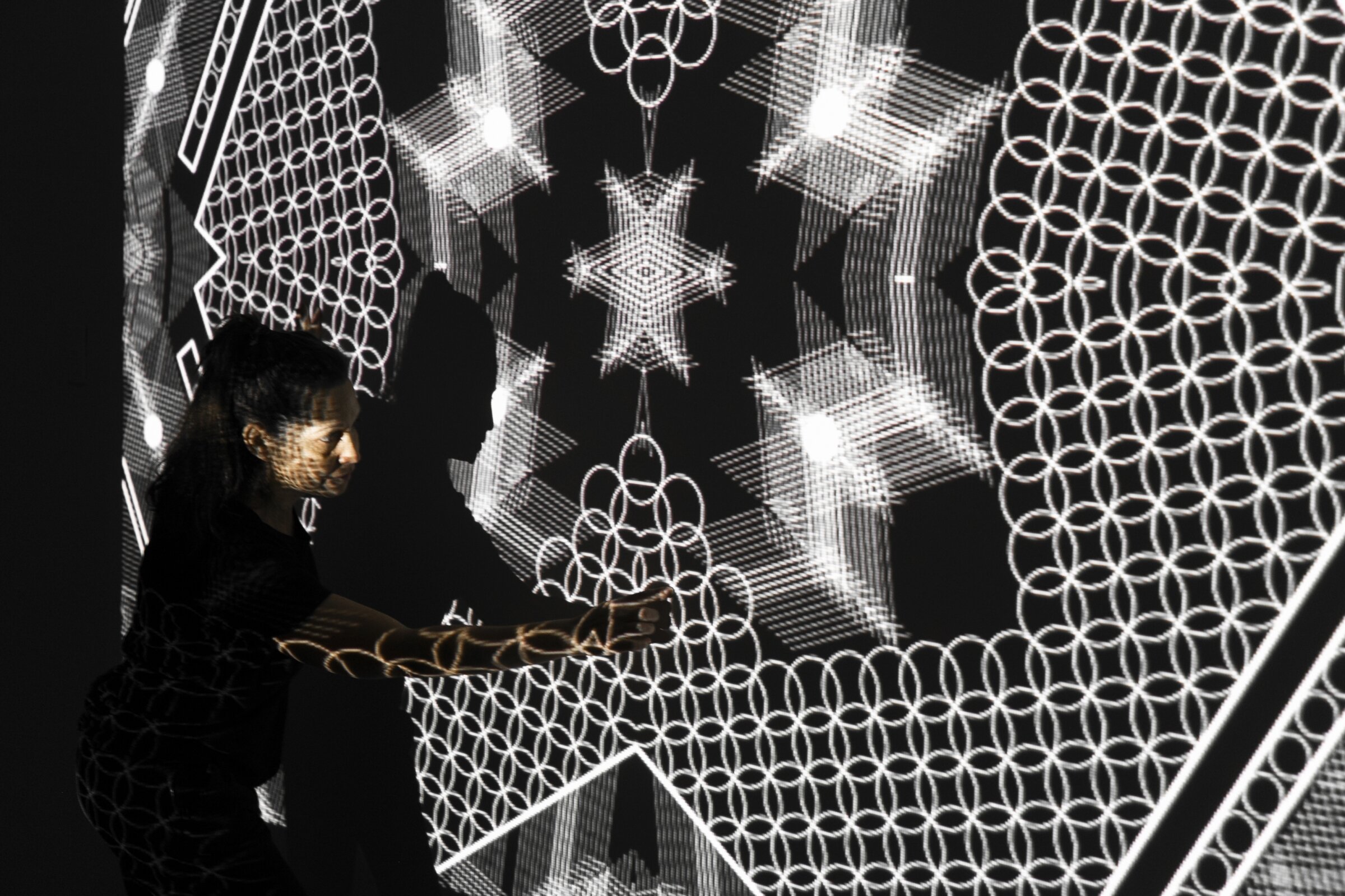 Tal Frank in studio testing video projections for the carpet work in Homeline. Photo by Zony Maya.