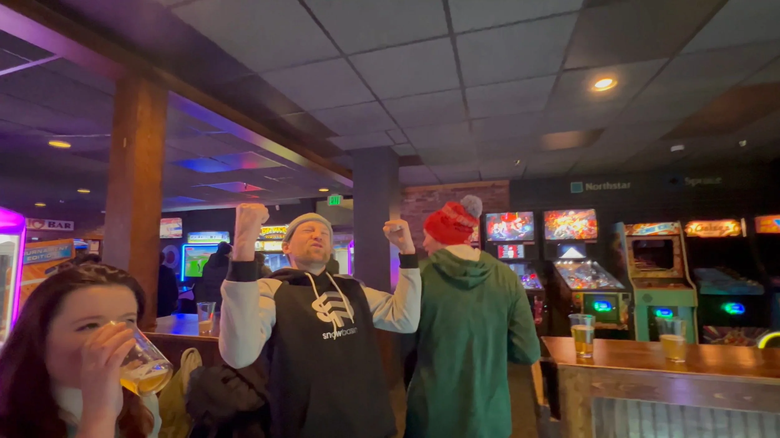 A happy man at a ski resort arcade.