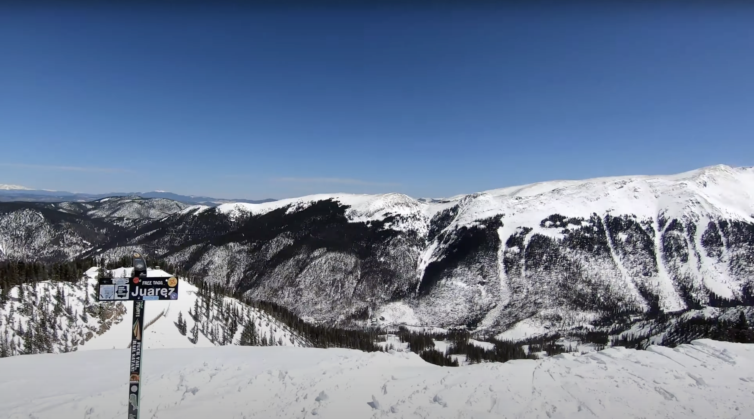 Standing at the top of a steep ridge at Taos ski resort, New Mexico