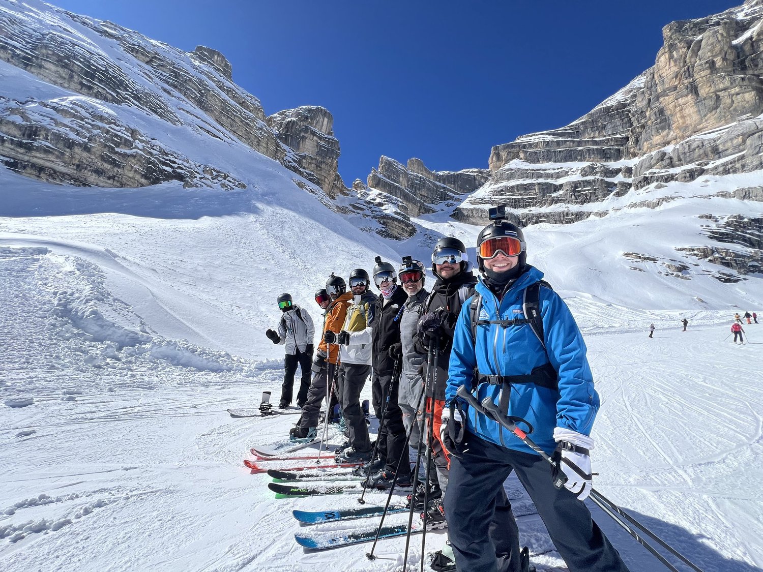 A PeakHouse group lined up on skis in Cortina