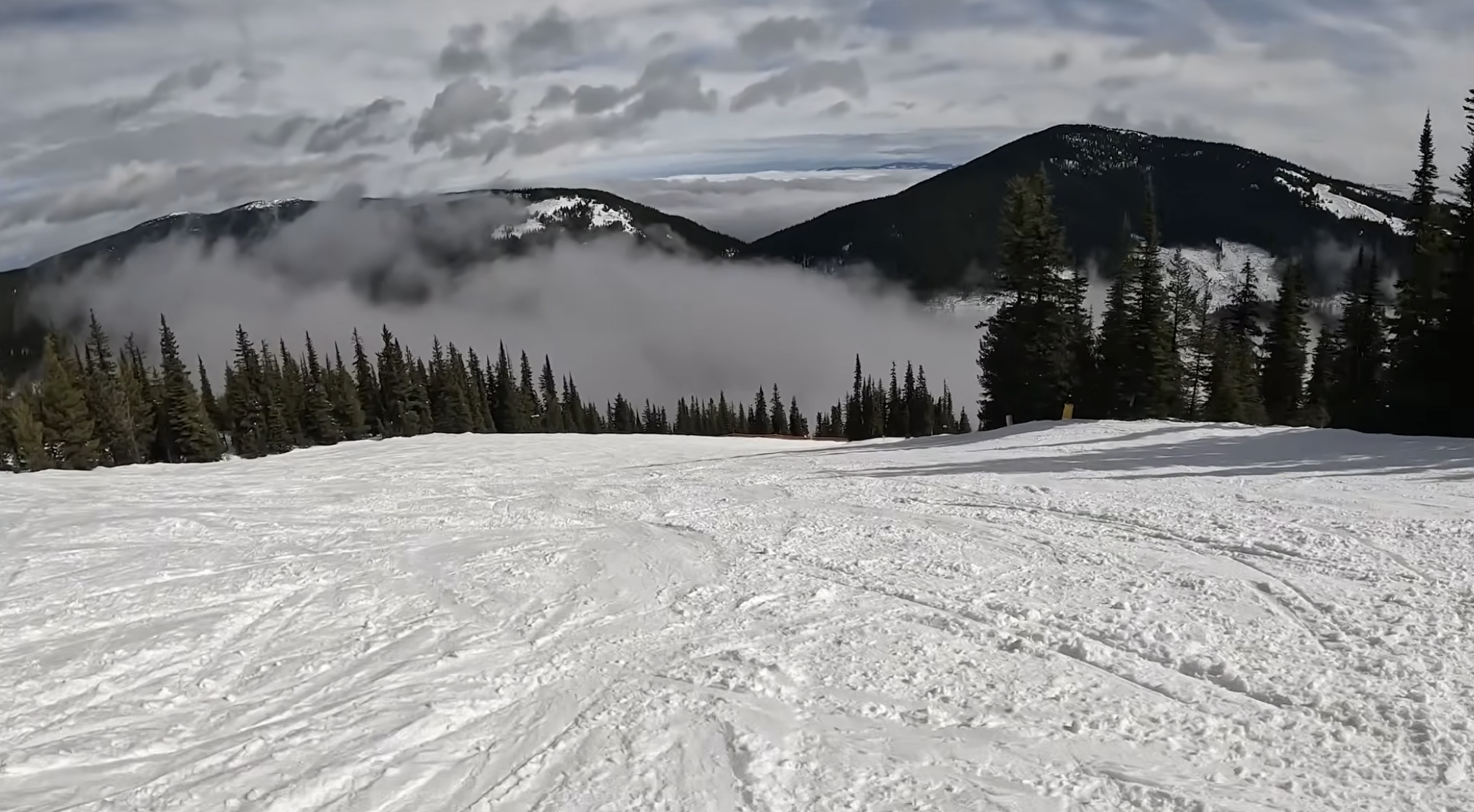 View of a ski run with low clouds at Apex ski resort, British Columbia