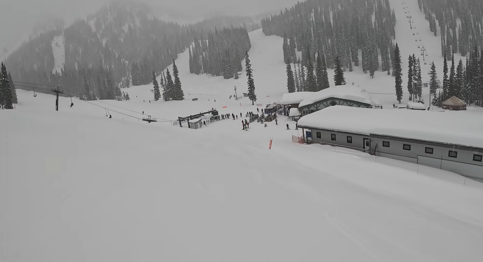A view of a ski resort base at Whitewater, British Columbia, with snowy buildings and ski lifts