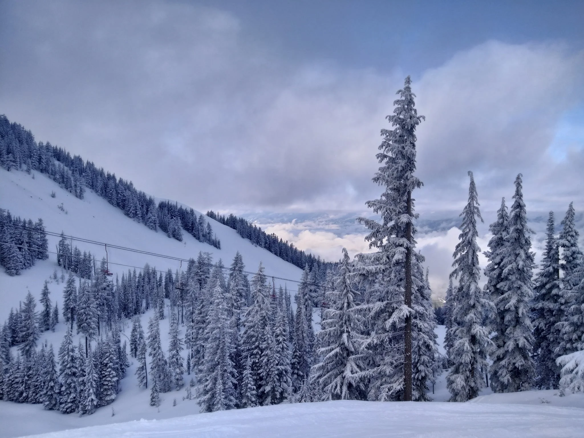 Chair 4, a red fixed-grip chairlift above snowy slopes at Silver Mountain