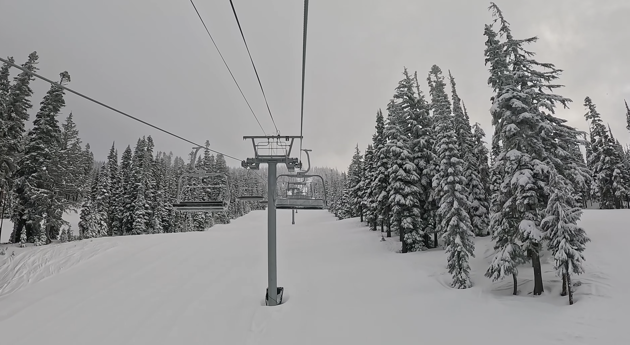 Riding up a chairlift on a cloudy overcast day at White Pass ski area, Washington state