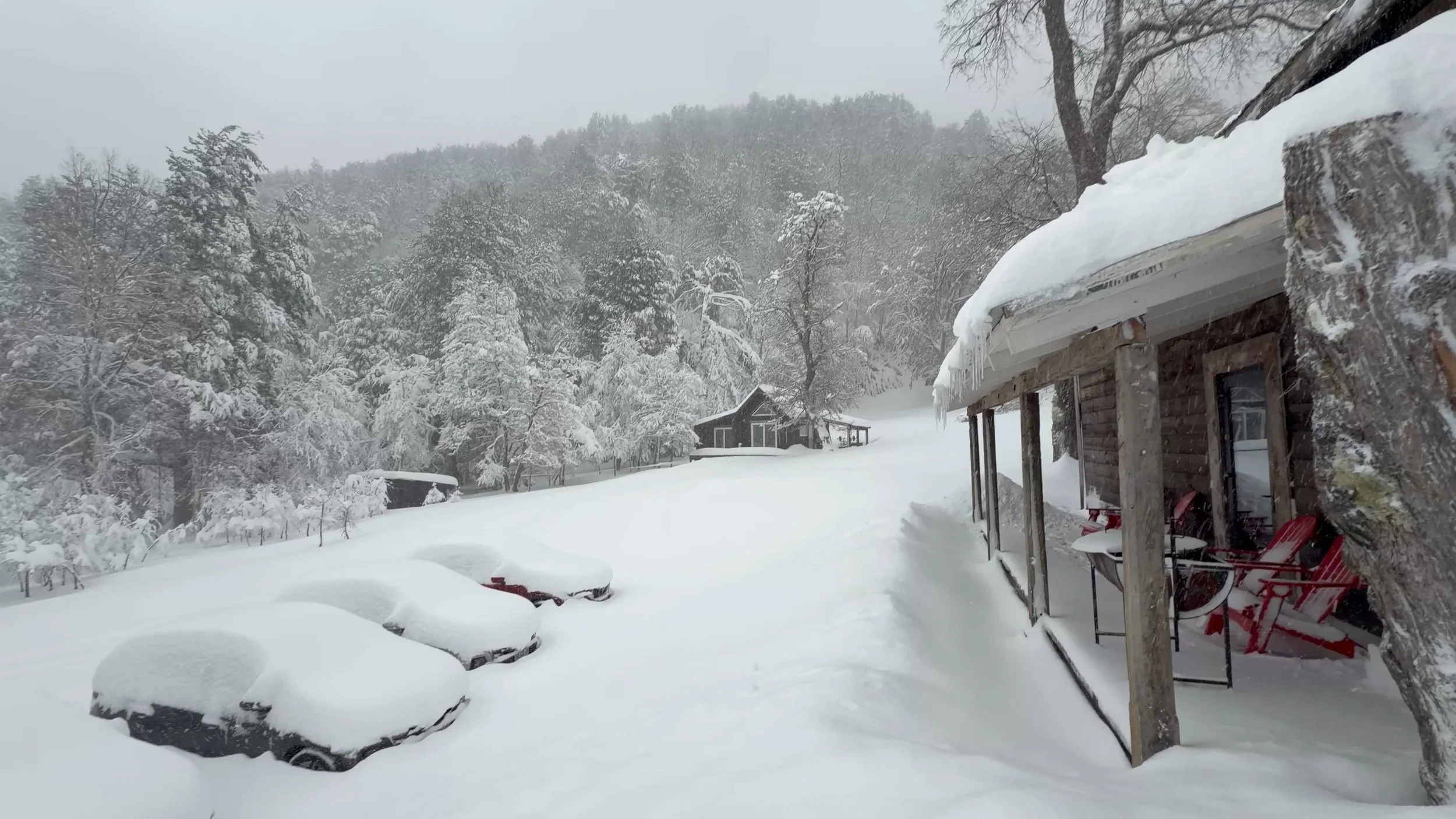 Huge snowstorm covering cars and houses in Corralco, Chile.
