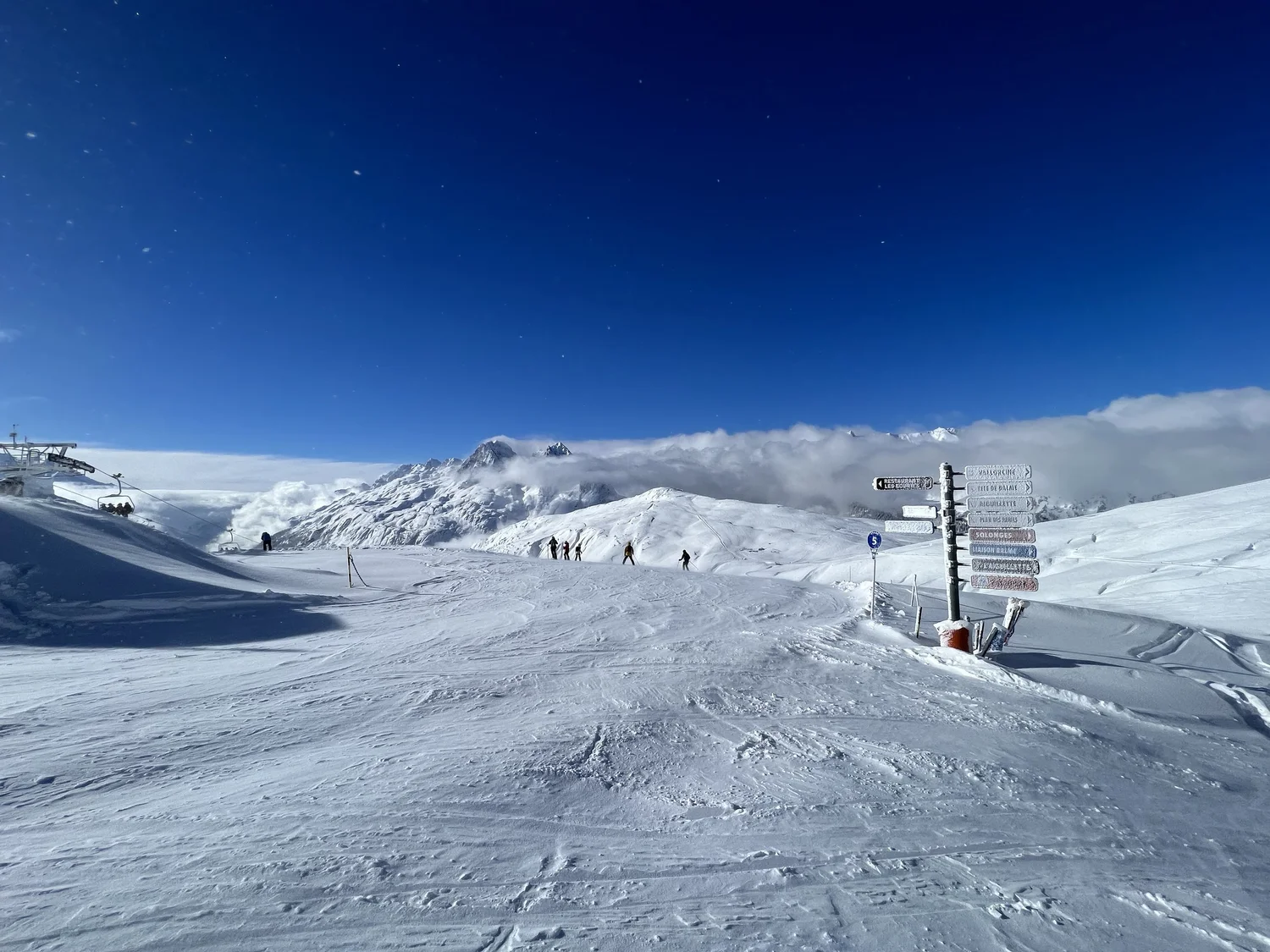 Piste signpost at Le Tour with peaks above the clouds