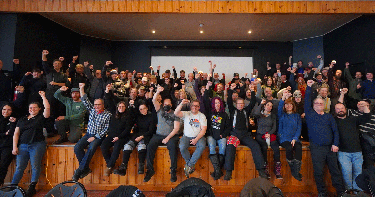 Group picture of unionized laborers raising their fists in solidarity