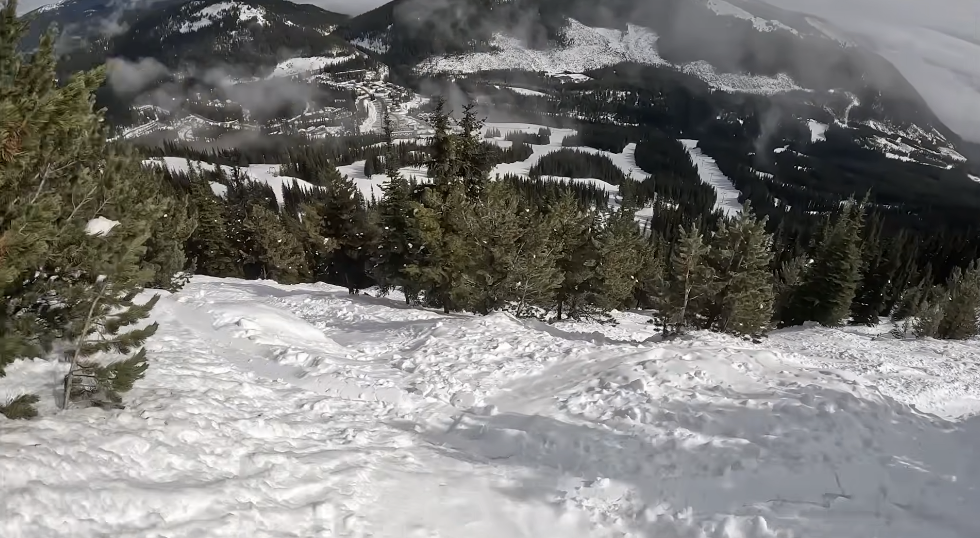 Looking down steep ski slope with trees at Apex mountain resort, British Columbia, Canada