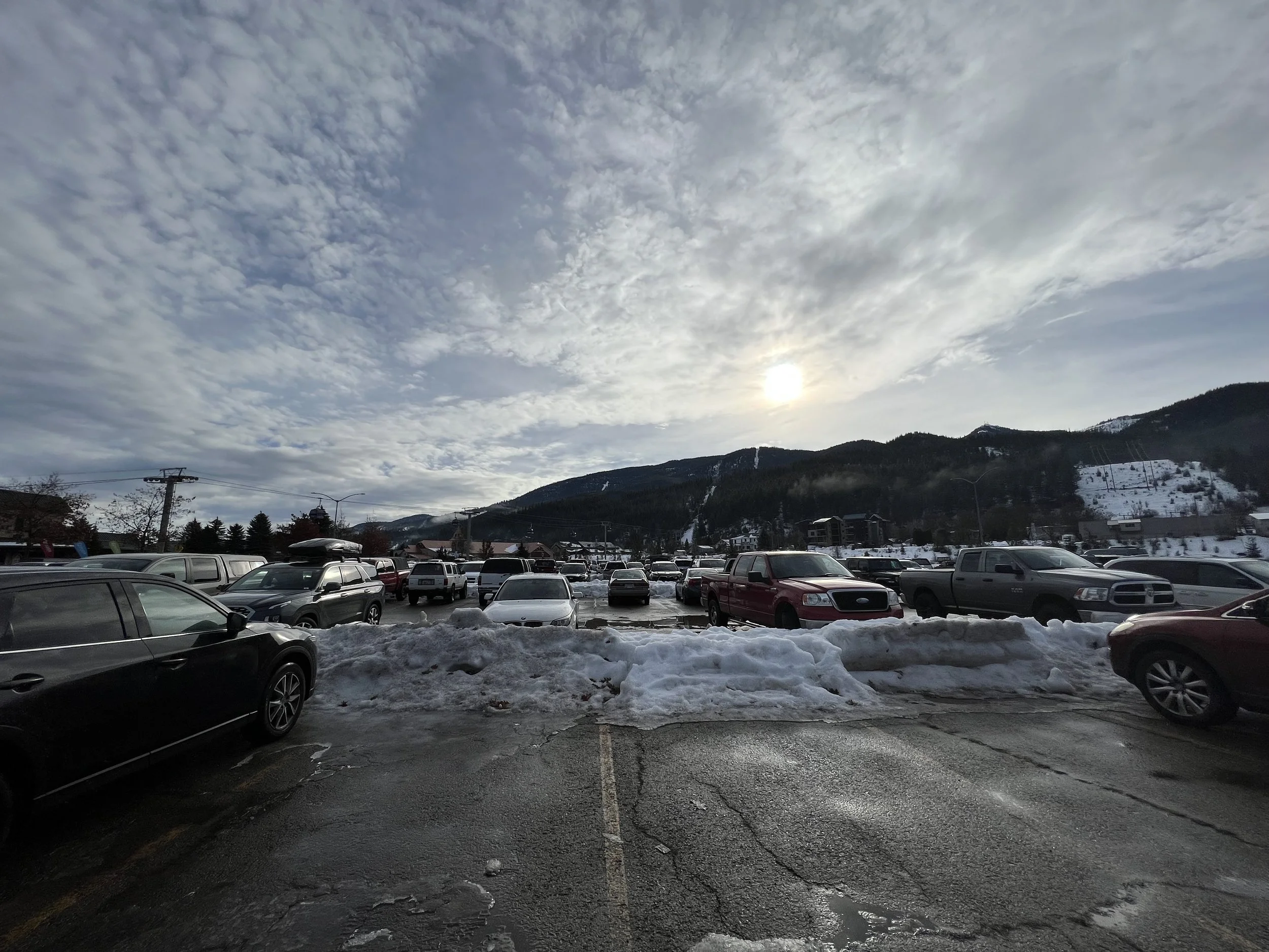 Cars parked in the snowy lot at the base of Silver Mountain