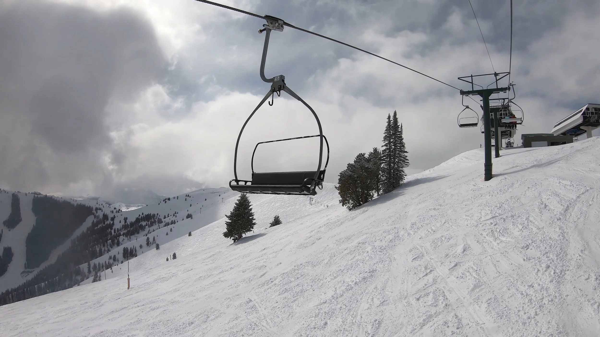 A ride up a Yan lift at Sun Valley ski resort with beautiful ski mountains in the background.