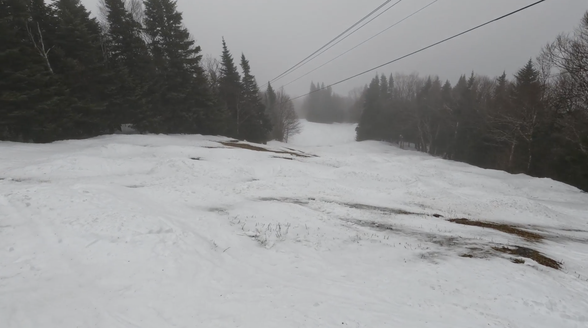Skiing down a patchy bumpy trail at Burke ski resort, Vermont