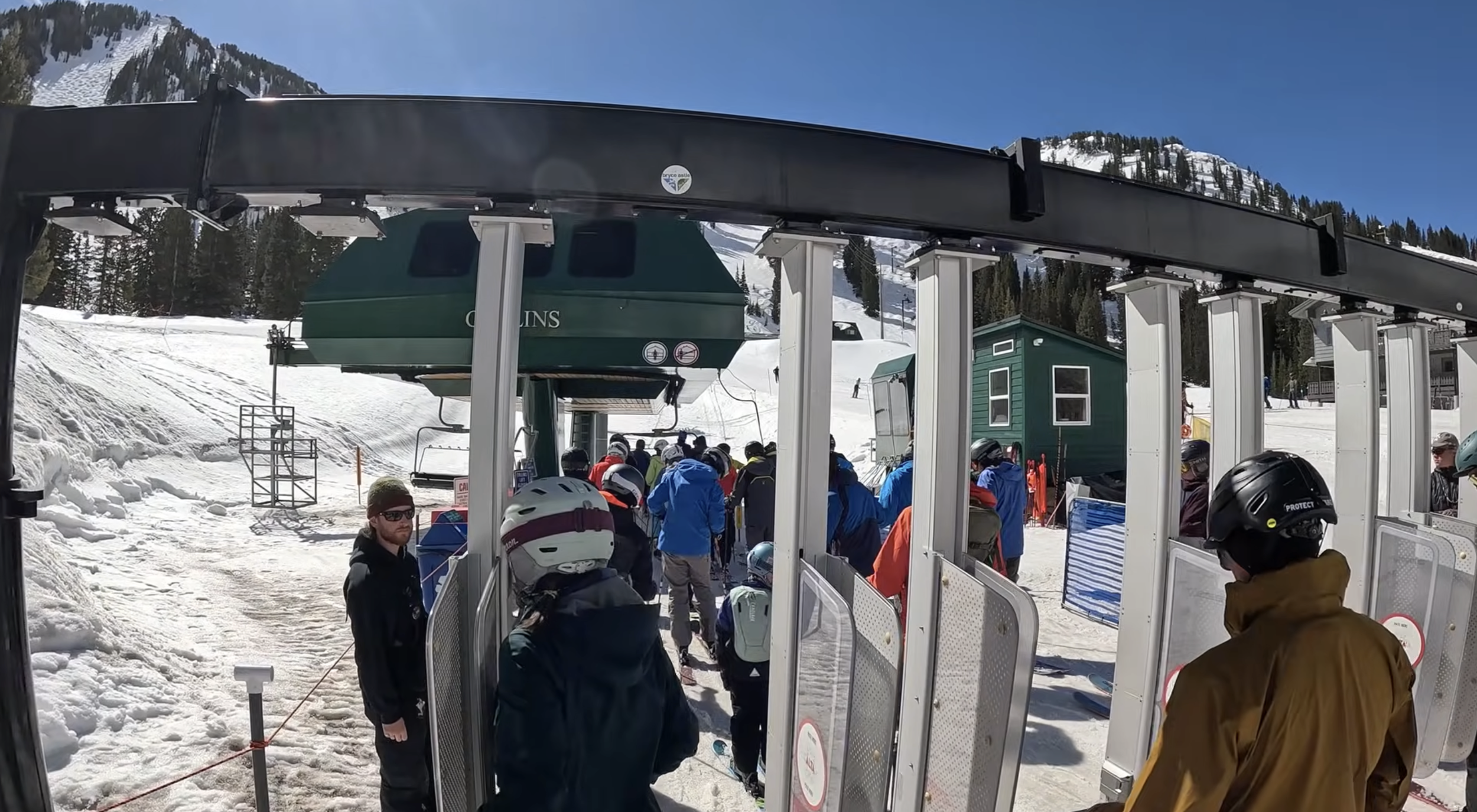 Skiers going through a ticket scanning gate before boarding a chairlift at Alta ski resort, Utah