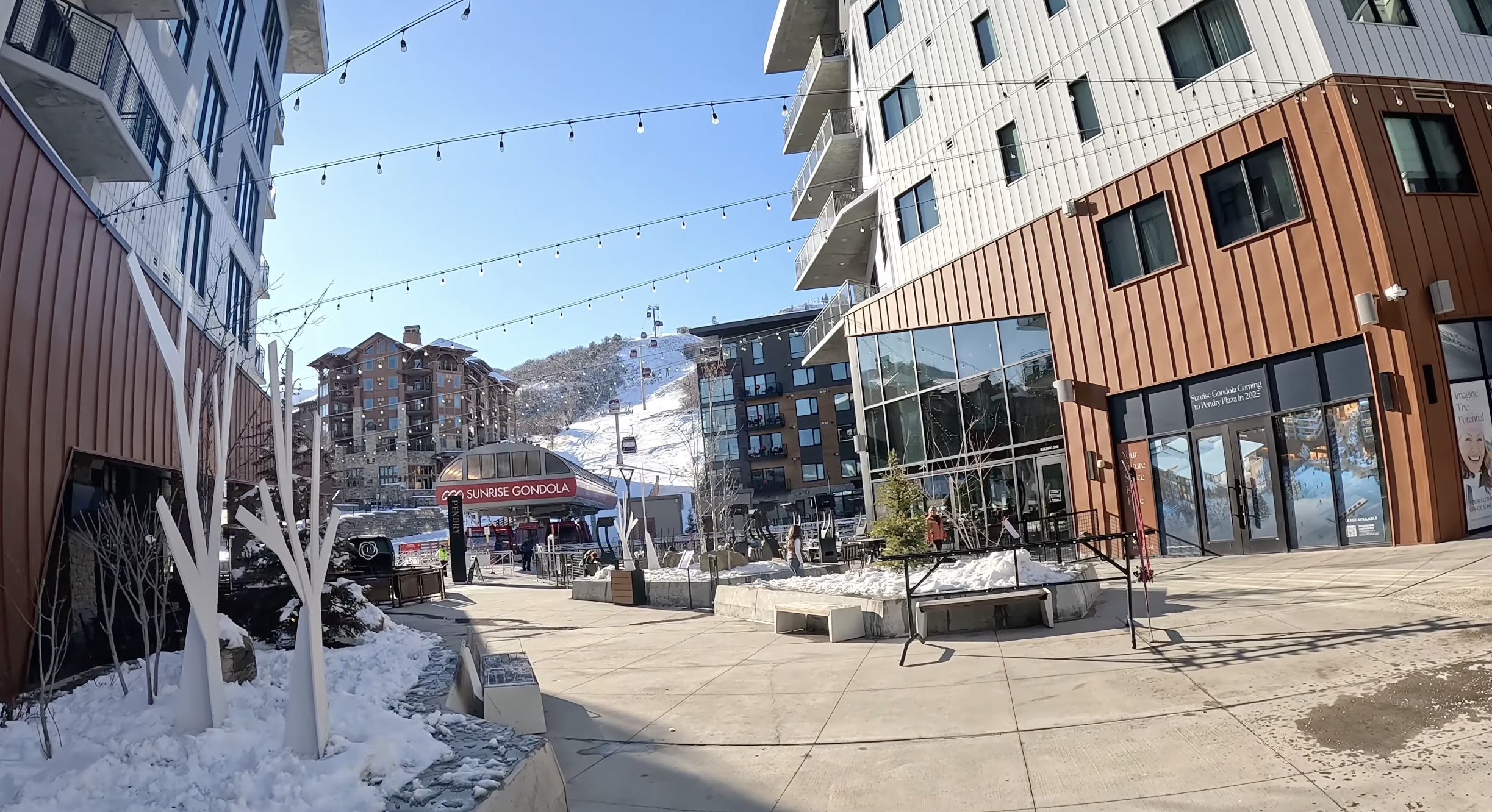 Walking through a fancy ski village toward a gondola station at Park City ski resort, Utah