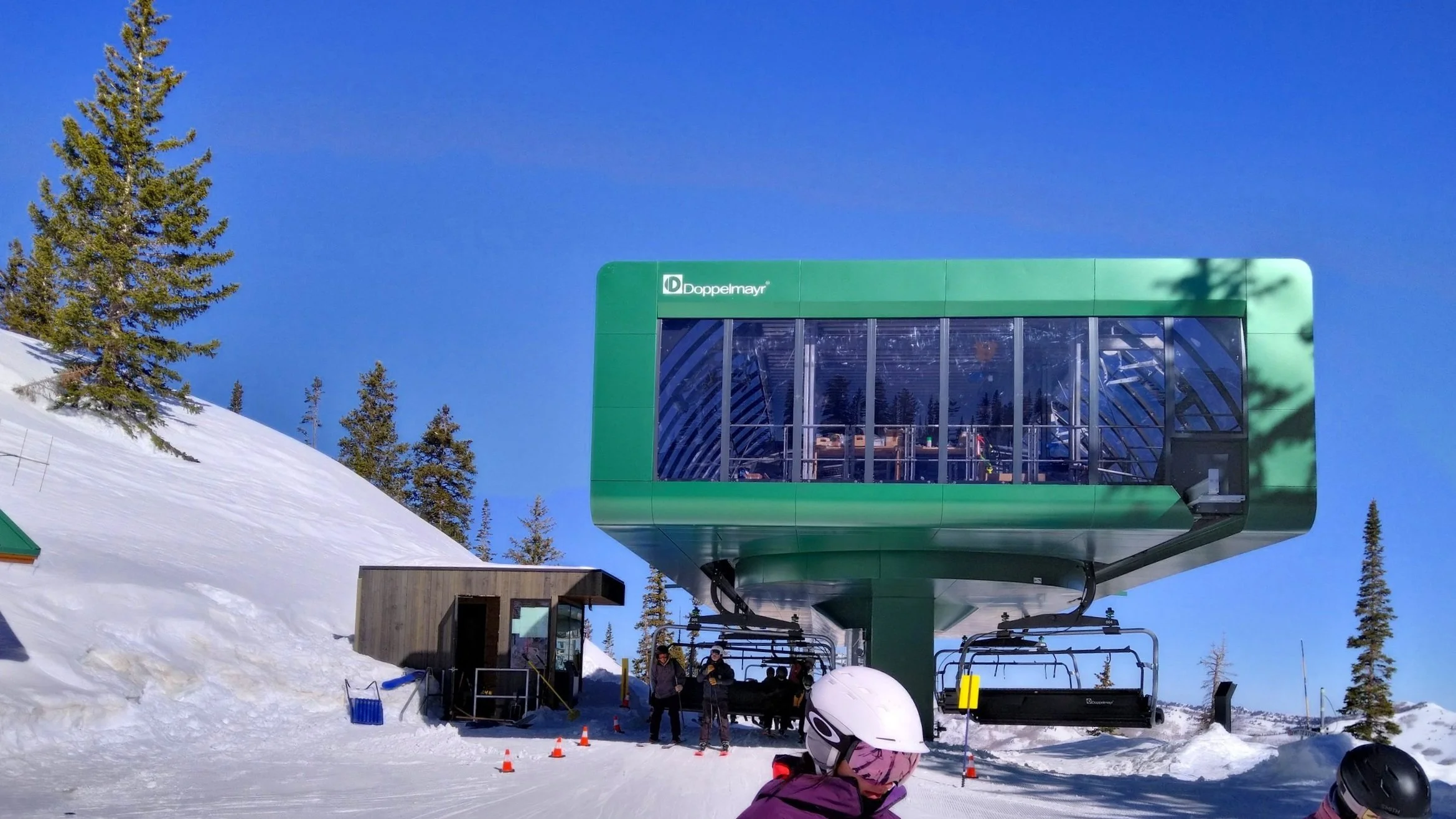 A modern and sleek chairlift terminal on a sunny day at Brighton ski resort, Utah