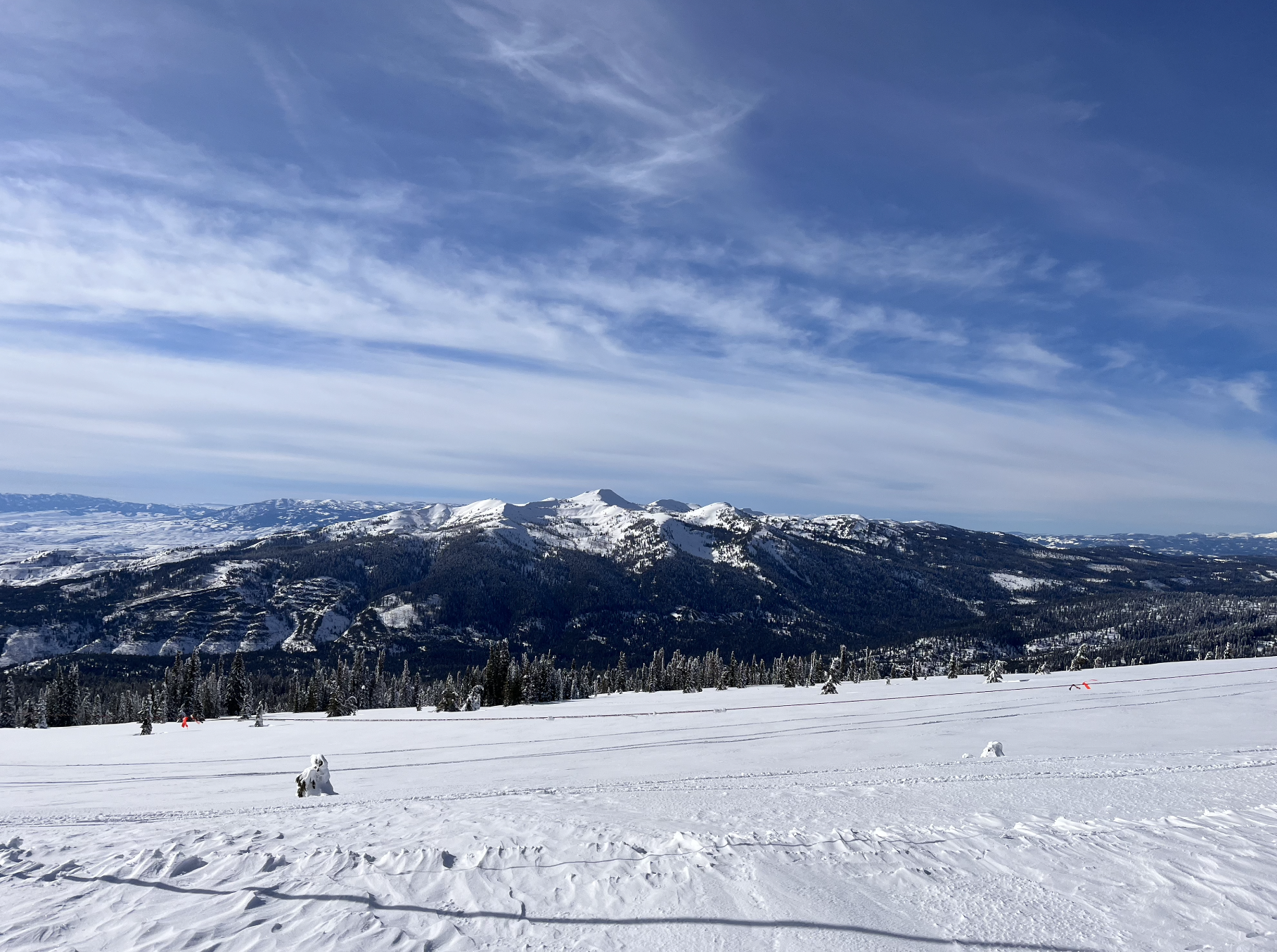 A view of snowy mountains from an undisturbed snowfield at Tamarack ski resort, Idaho