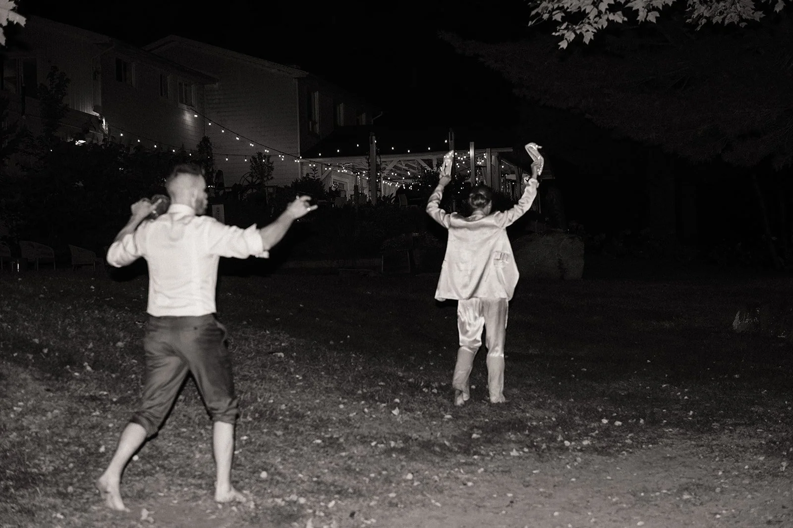 A couple dancing barefoot on a gravel yard on their wedding night at Northridge Inn Resort in Muskoka.